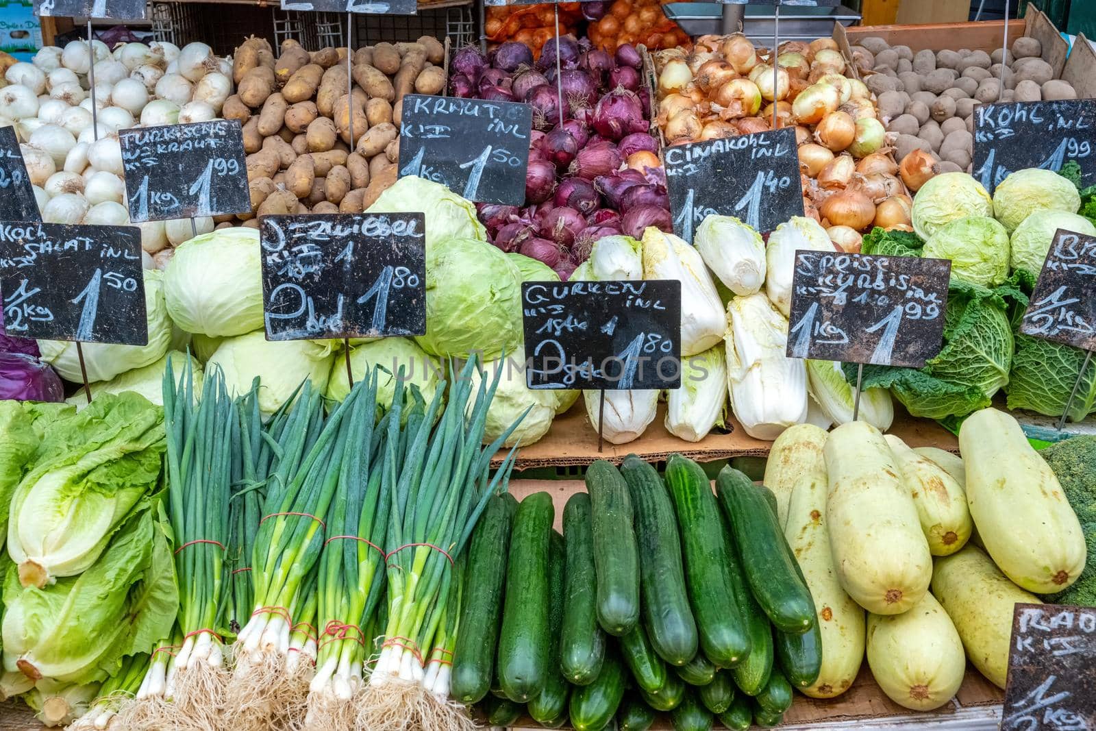 Big choice of vegetables and salad for sale at a market