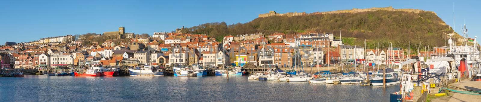 Harbor seafront town with castle on hill by paulvinten