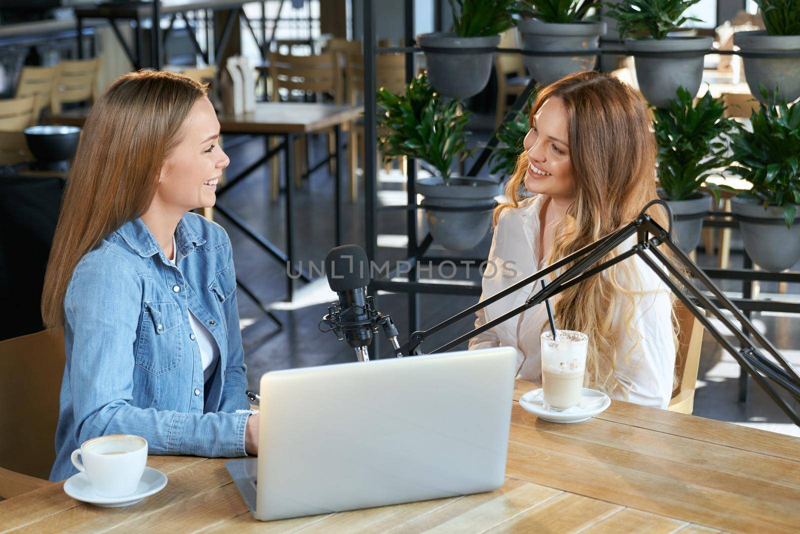 Two young blogger women talking with followers online.  by SerhiiBobyk