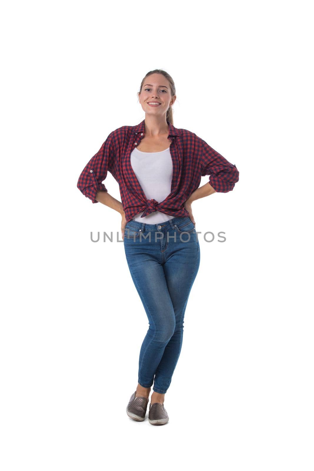 Full length portrait of smiling young woman with hands on waist isolated on white background, casual people