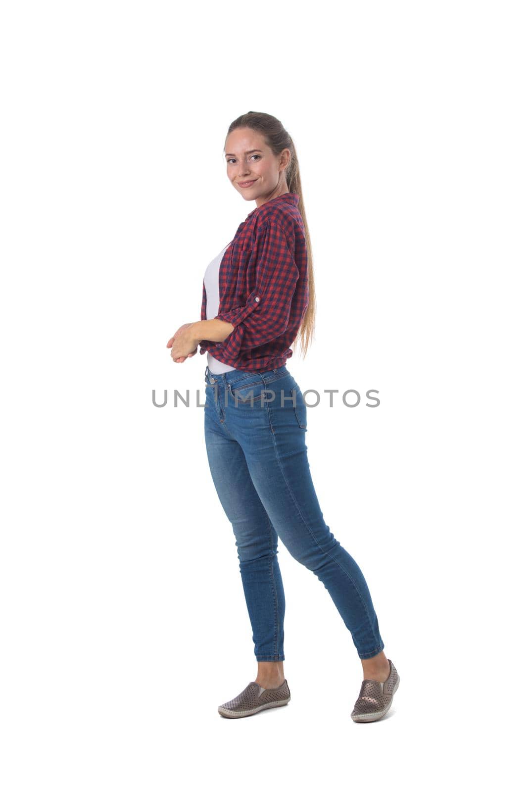 Full length portrait of young woman standing isolated on white background, casual people