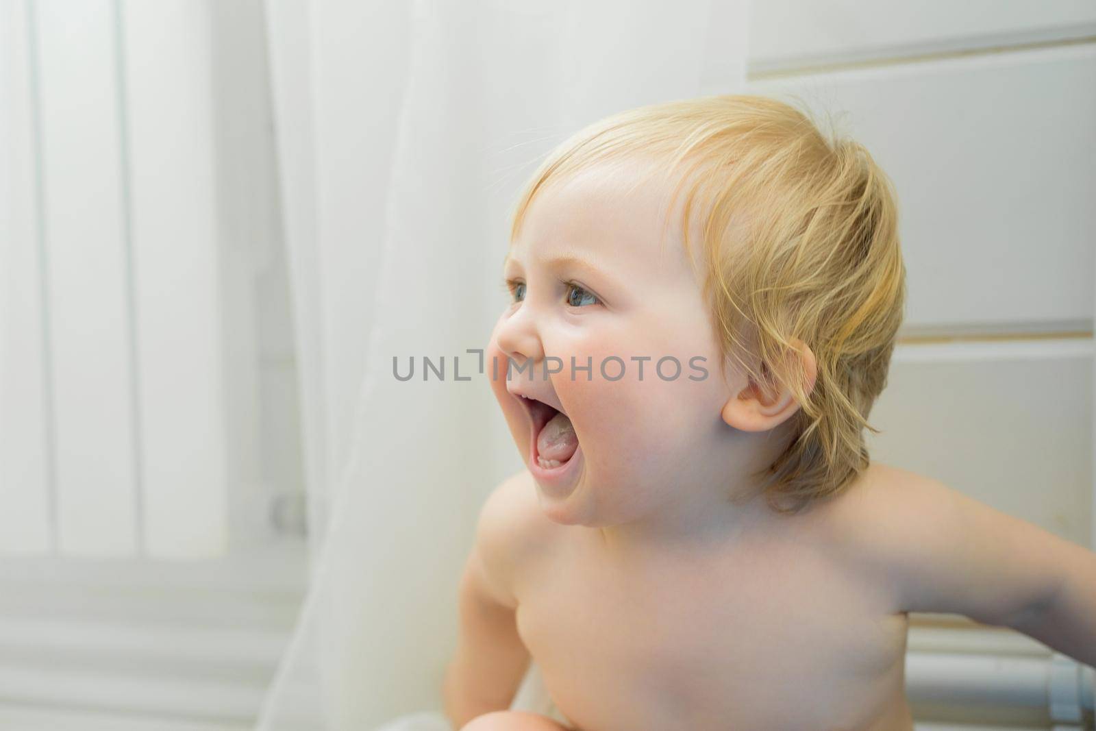 The kid looks at mom and rejoices and laughs. Close-up by Yurich32