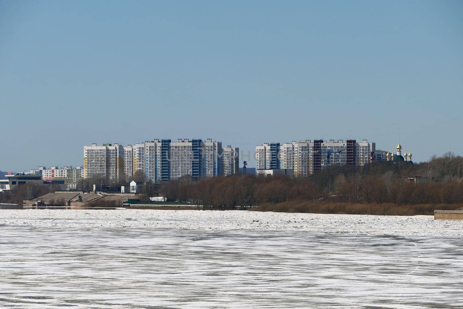 Spring ice on the river. Panorama is a city by the river. by Olga26