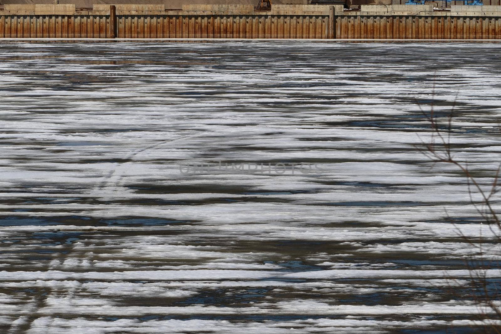 Spring ice on the river. Split the ice on the water in the river. High quality photo