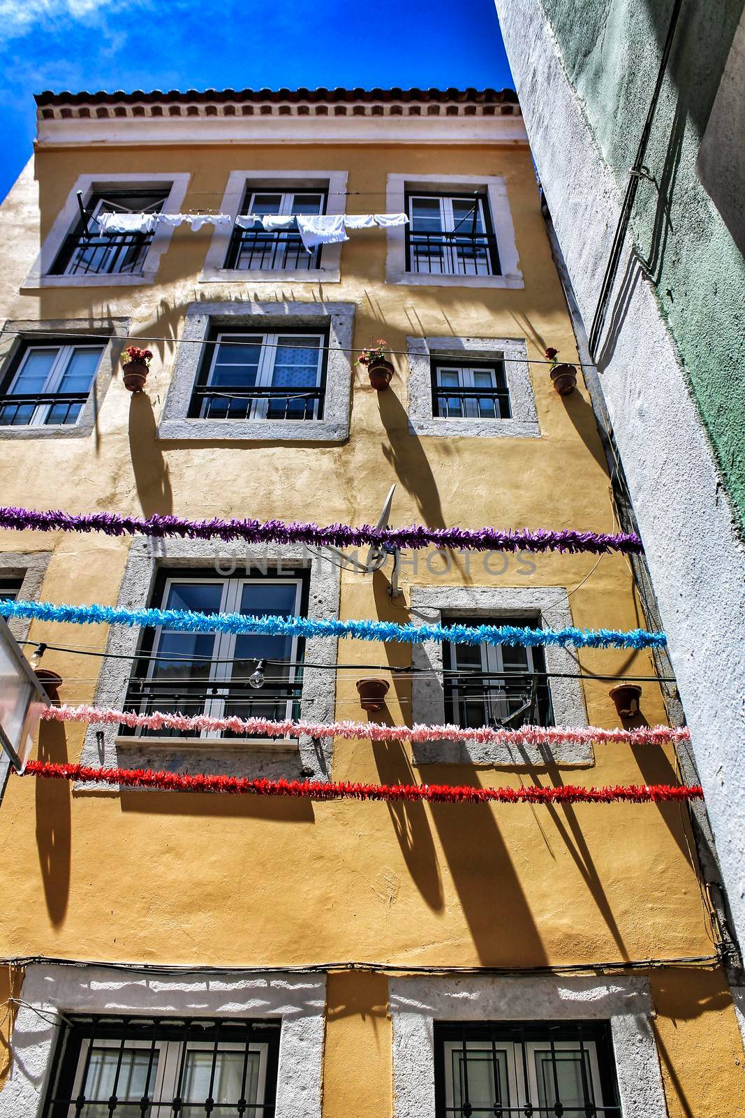 Streets adorned with garlands in Alfama, Lisbon by soniabonet