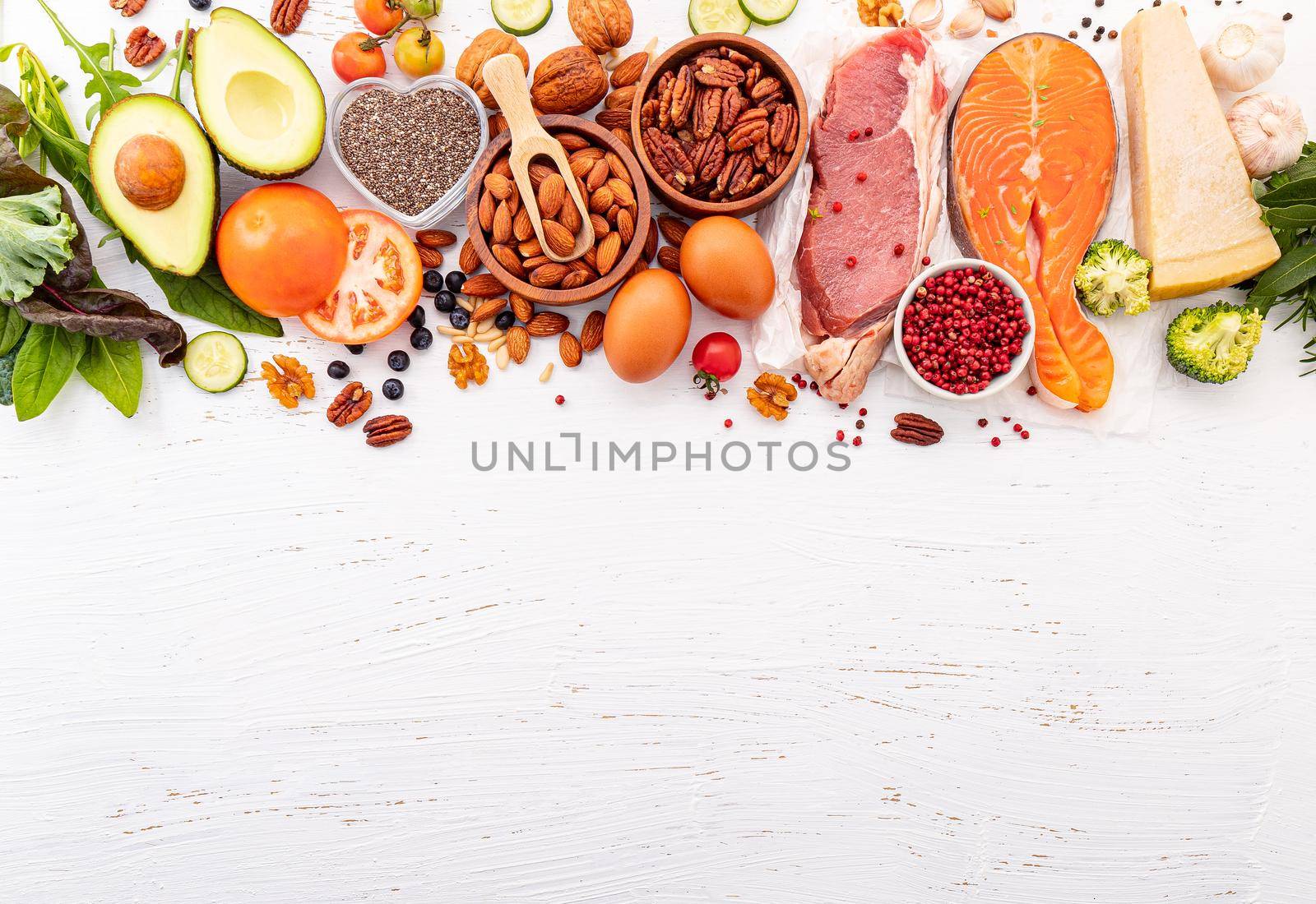 Ketogenic low carbs diet concept. Ingredients for healthy foods selection on white wooden background. Balanced healthy ingredients of unsaturated fats for the heart and blood vessels. by kerdkanno