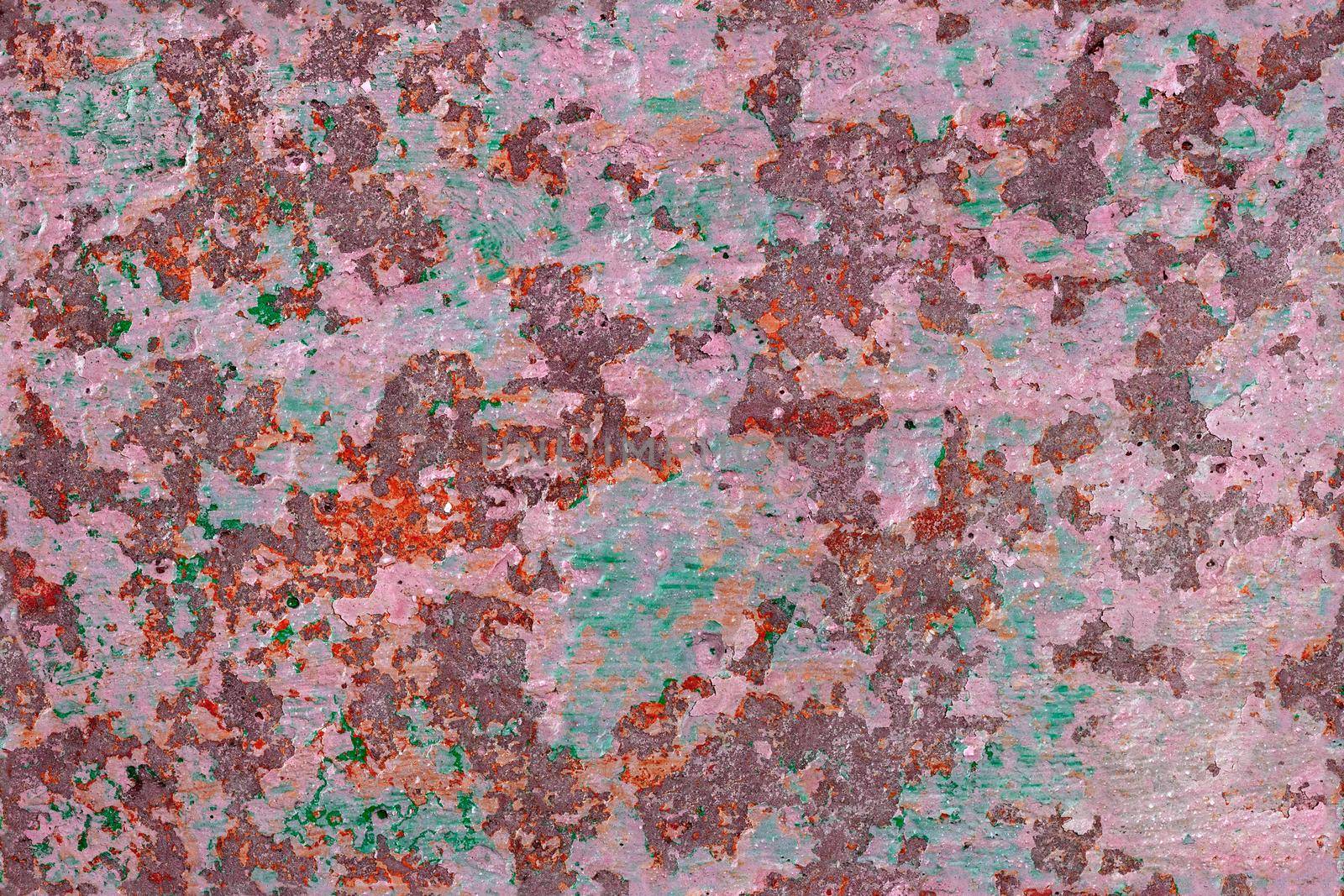 shabby peeled white, orange and green paint layers on concrete surface - flat background and seamless texture.