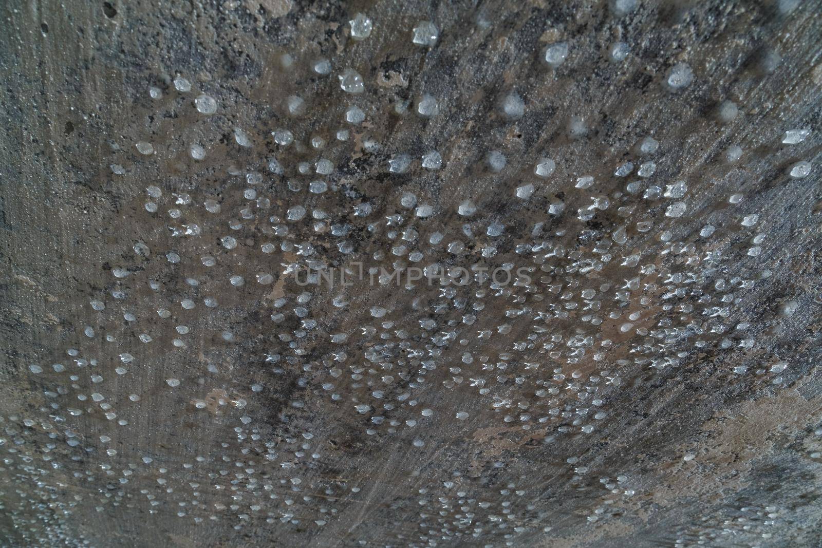 condensed water drops on the basement ceiling - close-up with selective focus.
