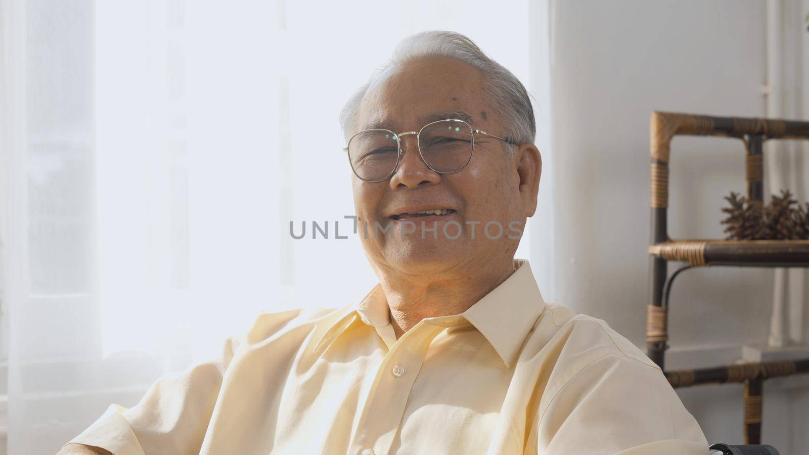 Portrait Asian happy face senior old man sitting in wheelchair smiling in nursing home, Closeup disabled man patient looking at camera, elderly healthcare