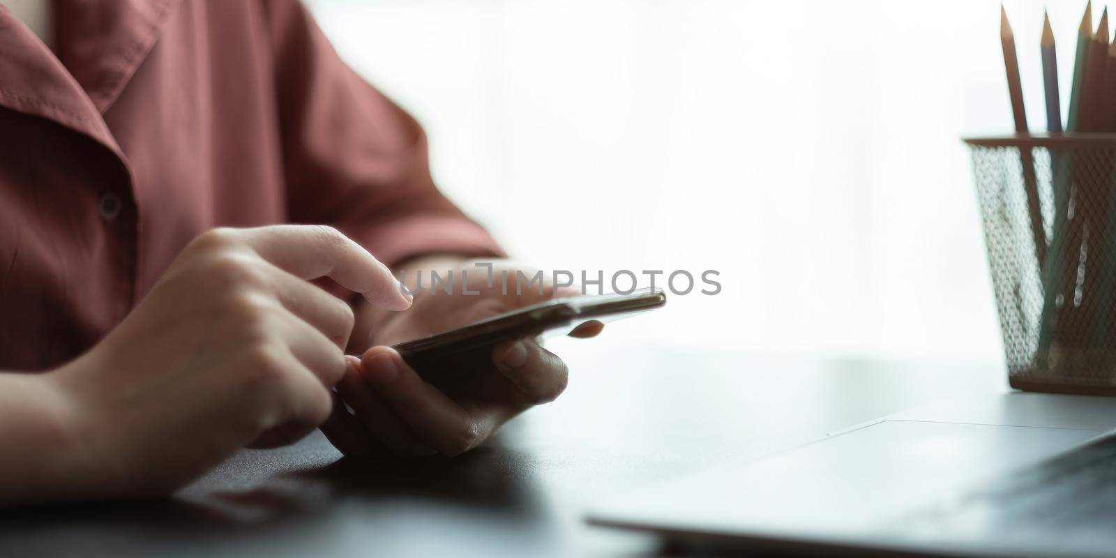 Close up hand of woman using smart phone by nateemee