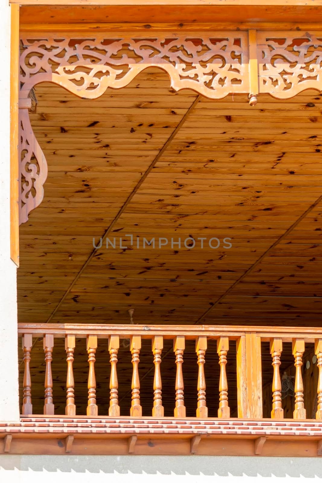 Veranda with carved wooden decor. Sunny autumn day. Front view. Crimea, Sudak - 10 October 2020. by Essffes