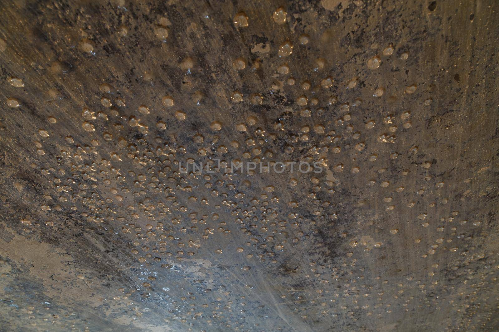 condensed water drops on the basement ceiling - close-up with selective focus.