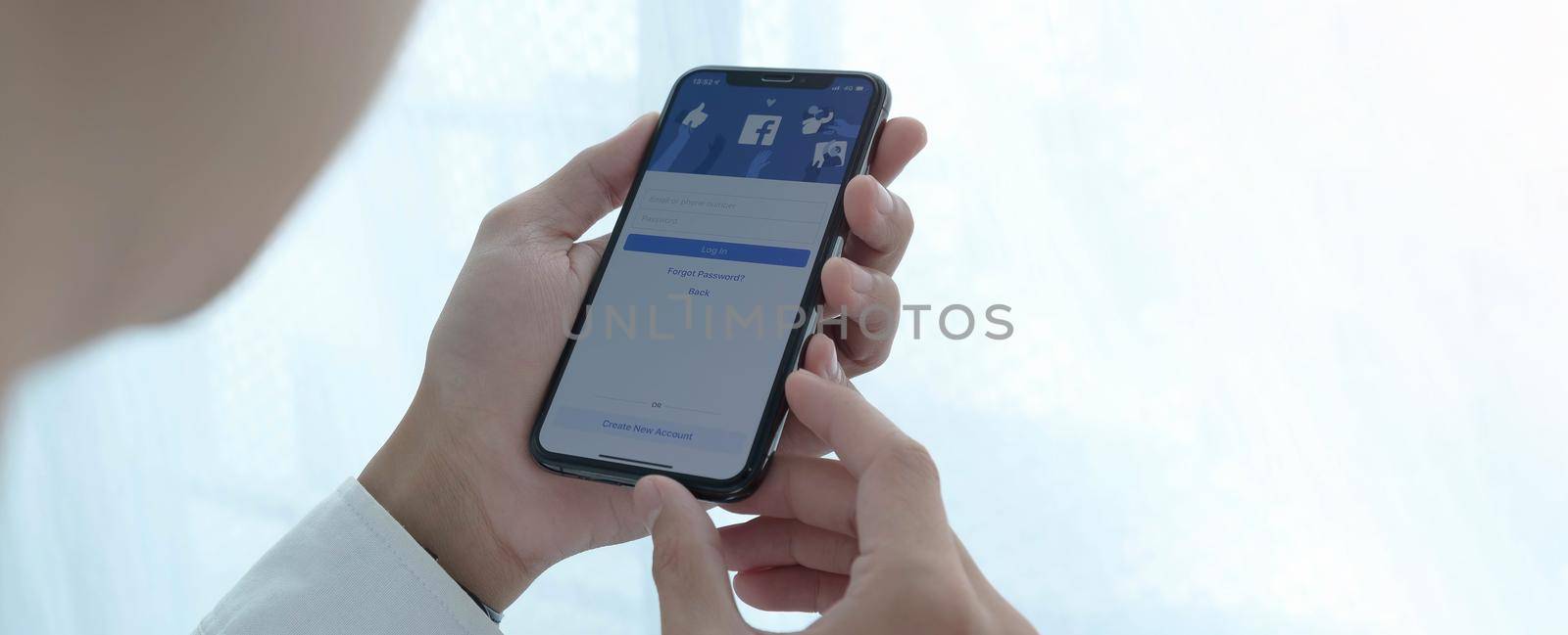 CHIANG MAI, THAILAND, JUL 27, 2020 : Facebook social media app logo on log-in, sign-up registration page on mobile app screen on iPhone smart devices in business person's hand at work.