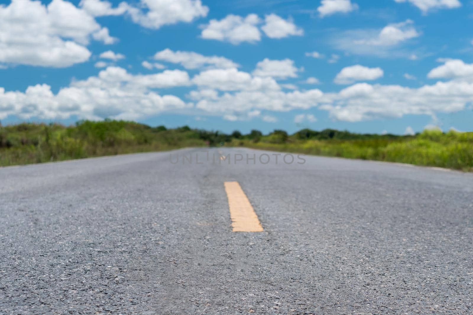 Small country road with blue sky background. by Suwant