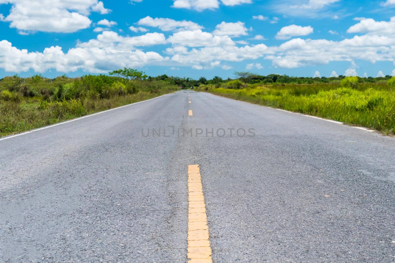 Small country road with blue sky background. by Suwant