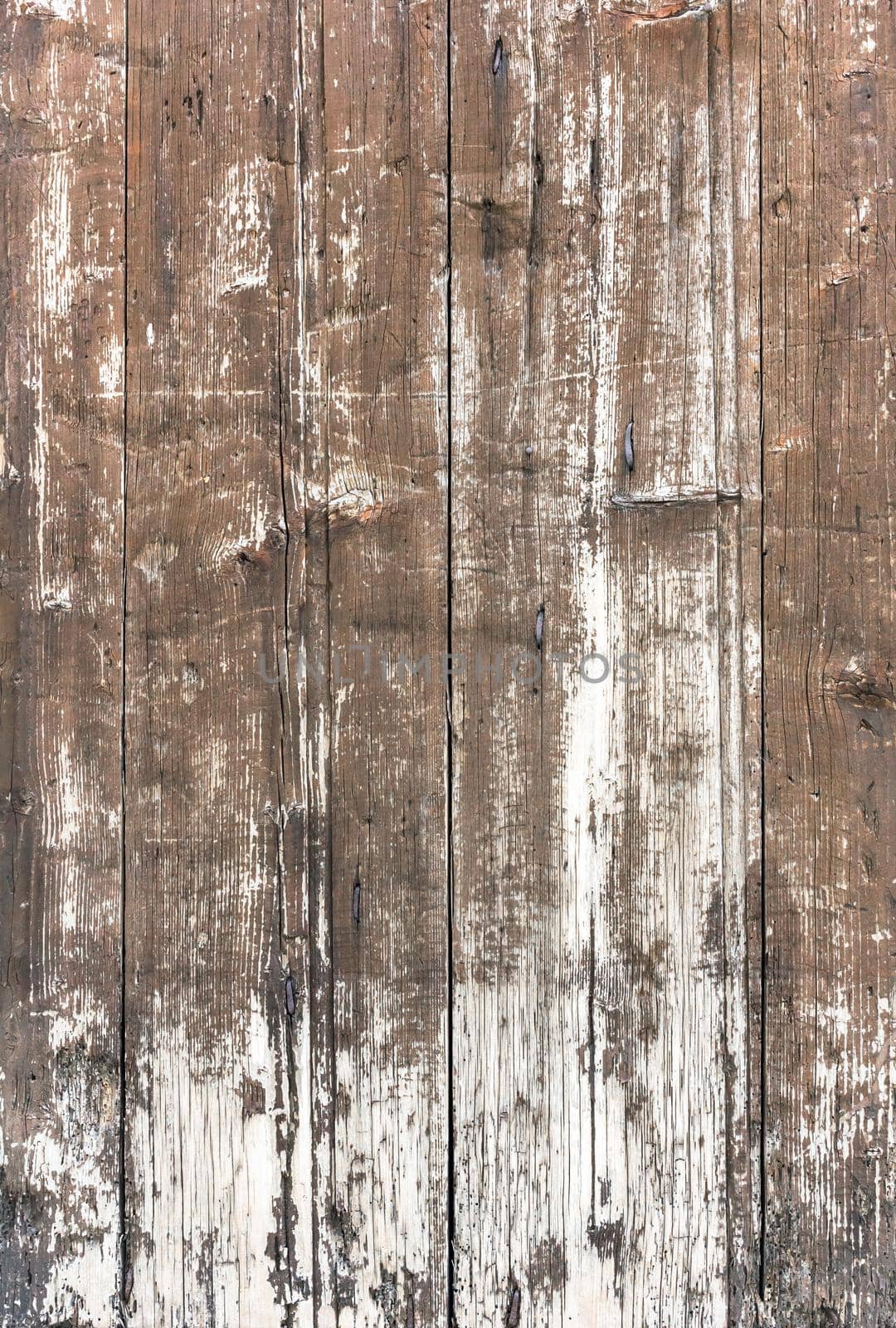Weathered wooden background. Old wooden plankswith peeling paint. Background of old painted wood fragment.