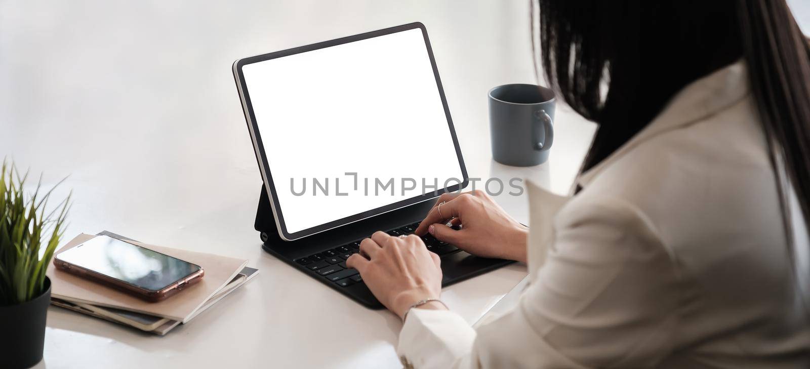 Business woman or accountant using tablet with blank screen
