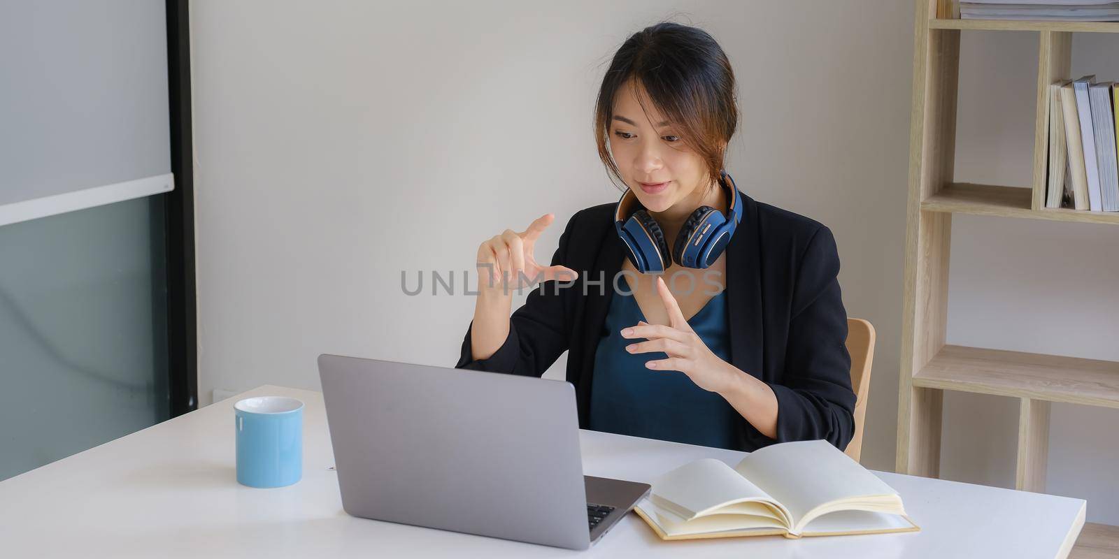 Portrait of businesswoman discussing to her partners about new product while video conference in home office