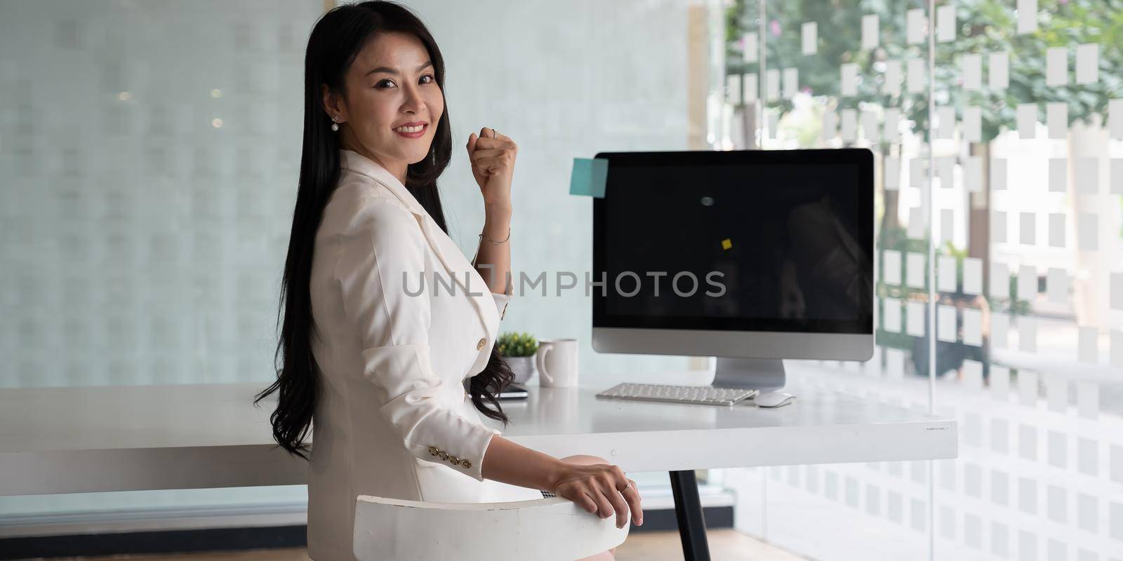 Portrait of Asian businesswoman smile and sitting at her office