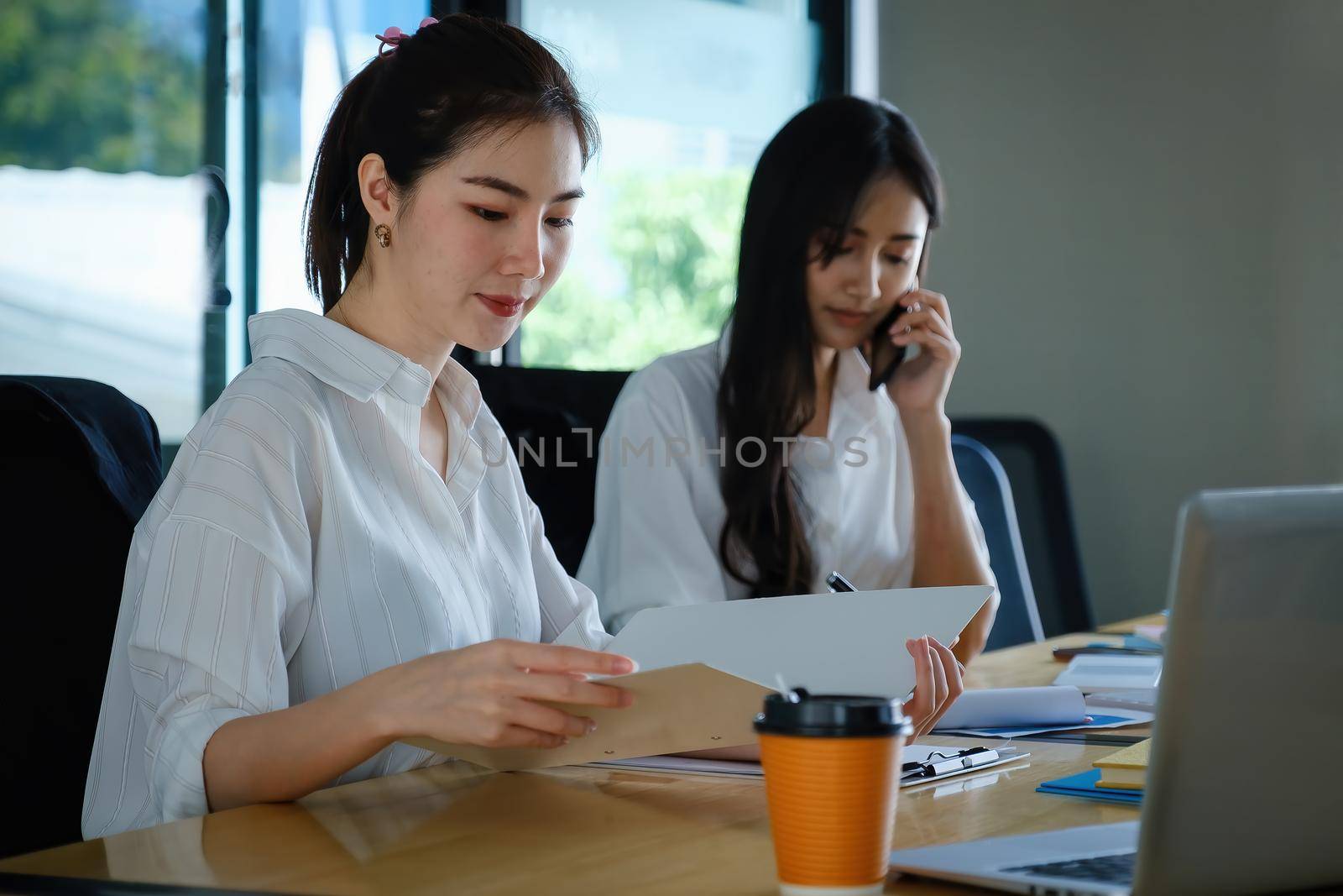 Two of Young business female working together and partners talking with customer