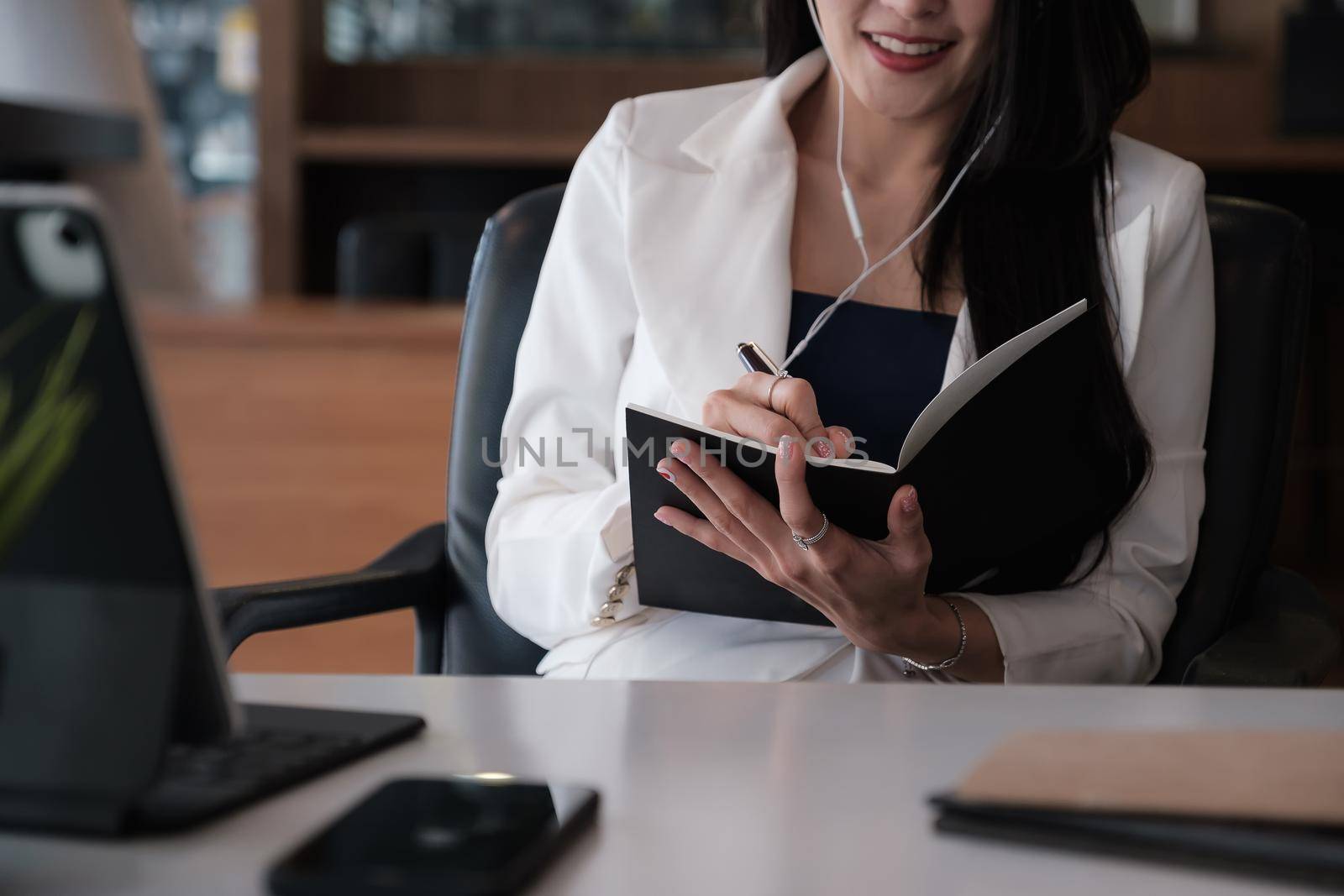 Business woman reading minute of meeting on her notebook in office. vintage effect and selective focus