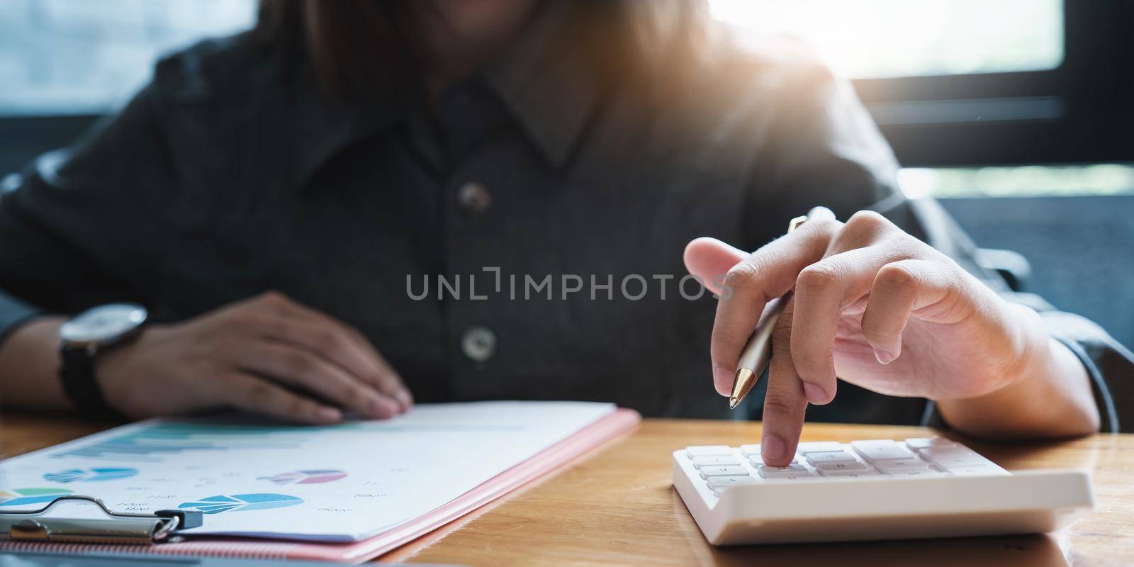 Business woman hand holding pen and cell phone with bank savings account application, account or saving money or insurance concept. by itchaznong