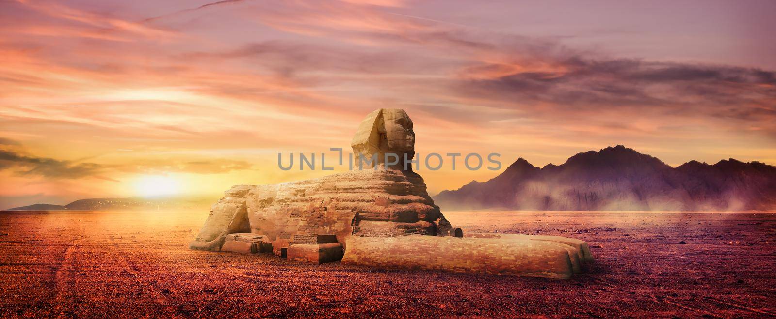 Great Sphinx in egyptian desert at foggy sunrise