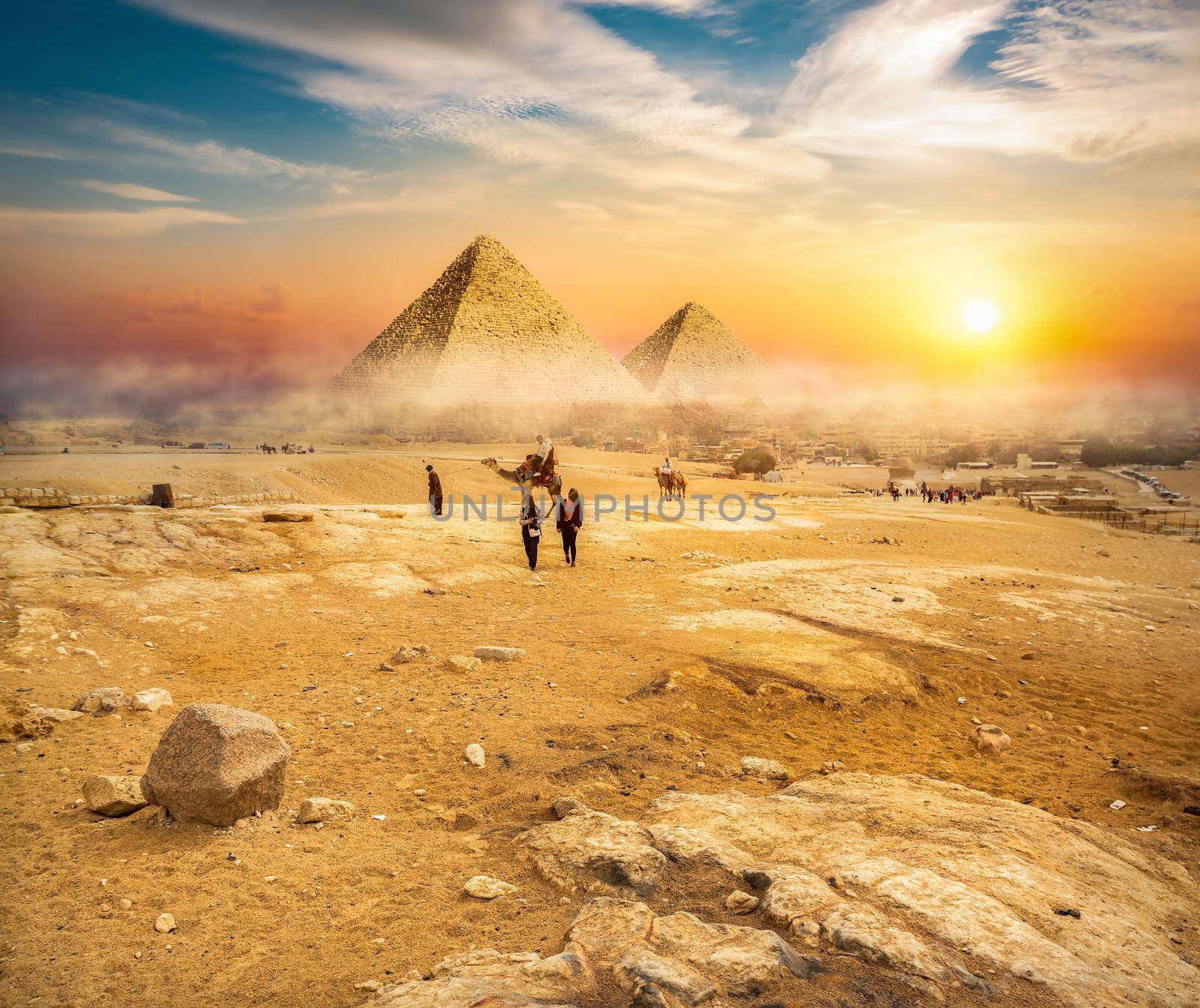 Egyptian pyramids in the desert at sunset