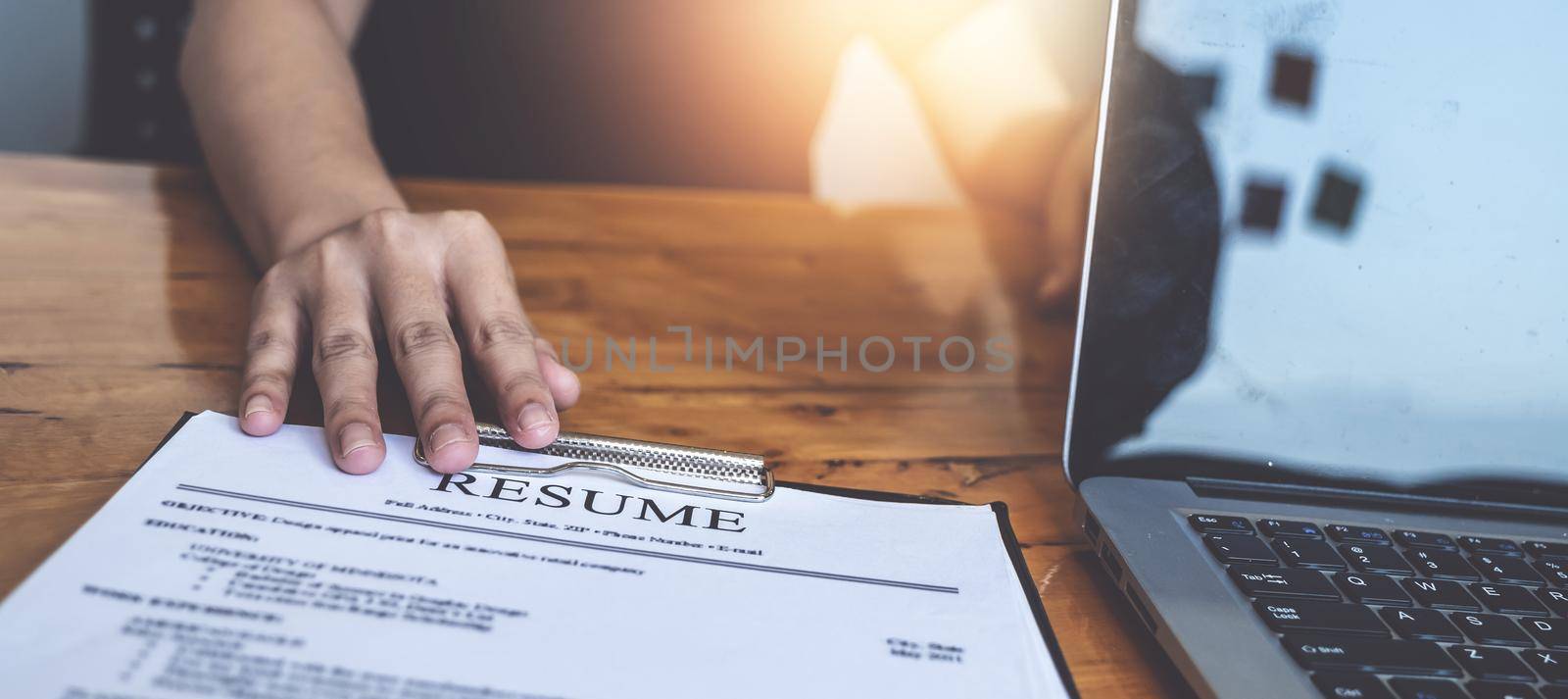 Businesswoman reading resume of man on document during an interview