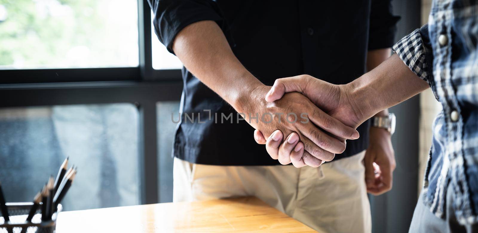 Image of Successful businessmen partnership handshaking after acquisition. Meeting for sign contracts and Group support concept. High quality photo.