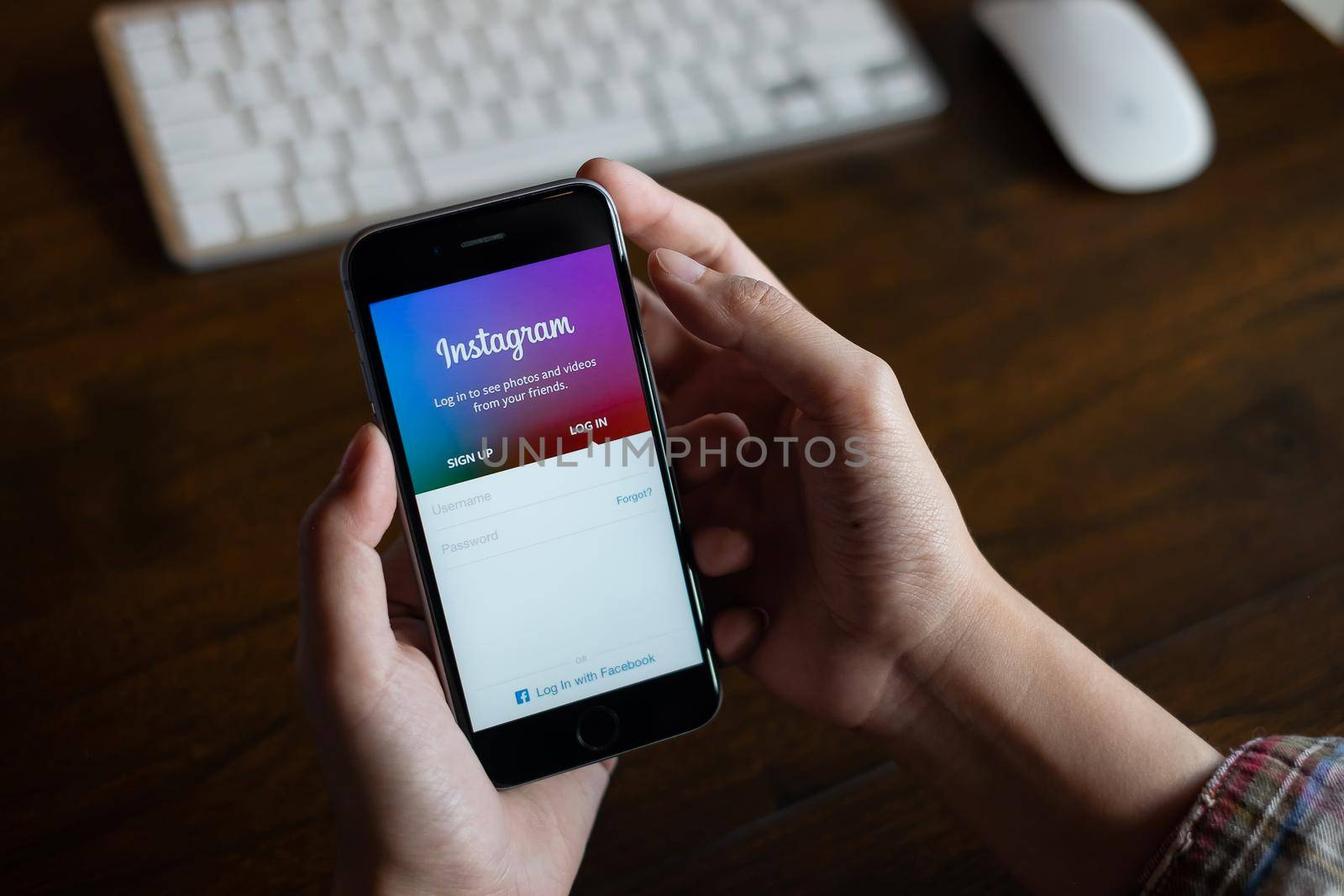 CHIANG MAI, THAILAND - FEB 26, 2020: A woman hand holding iphone with login screen of instagram application. Instagram is largest and most popular photograph social networking. by itchaznong