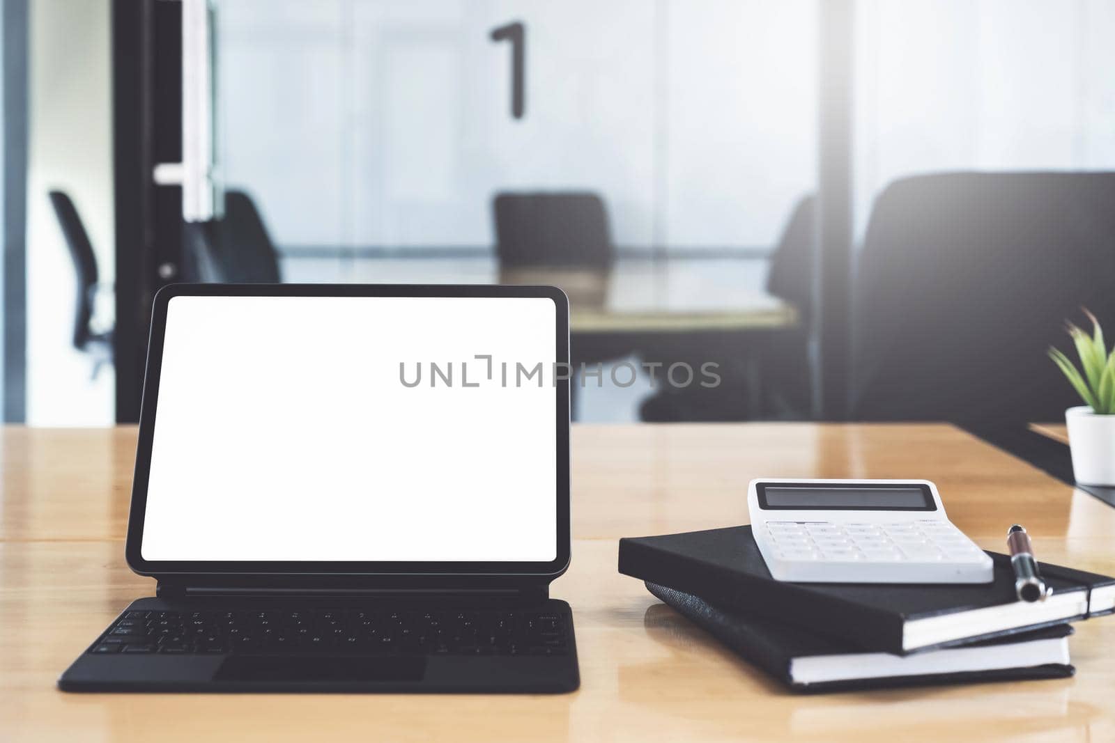 Digital tablet with blank screen on wooden desk