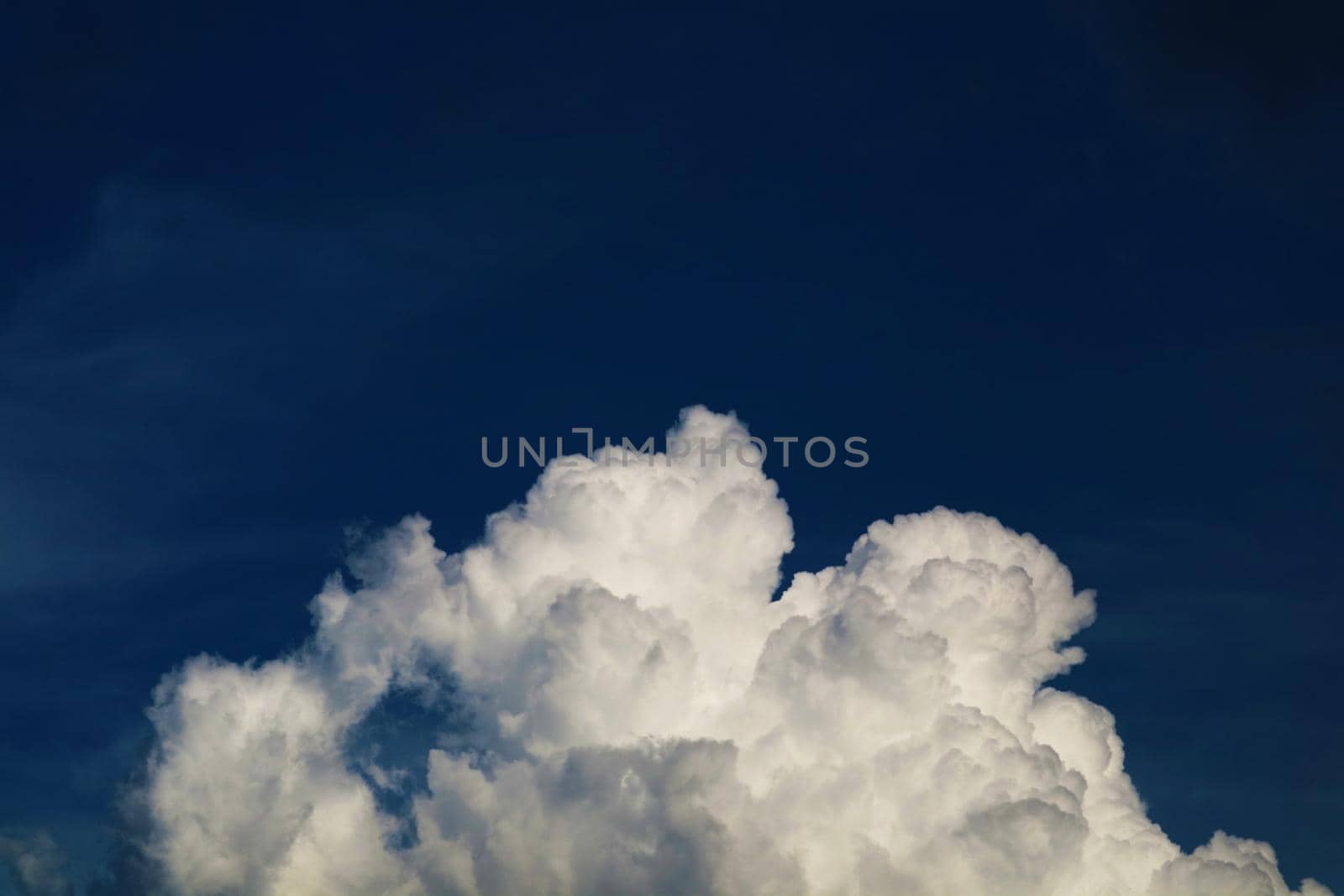 dark white heap cloud and and dark night blue sky in summer season