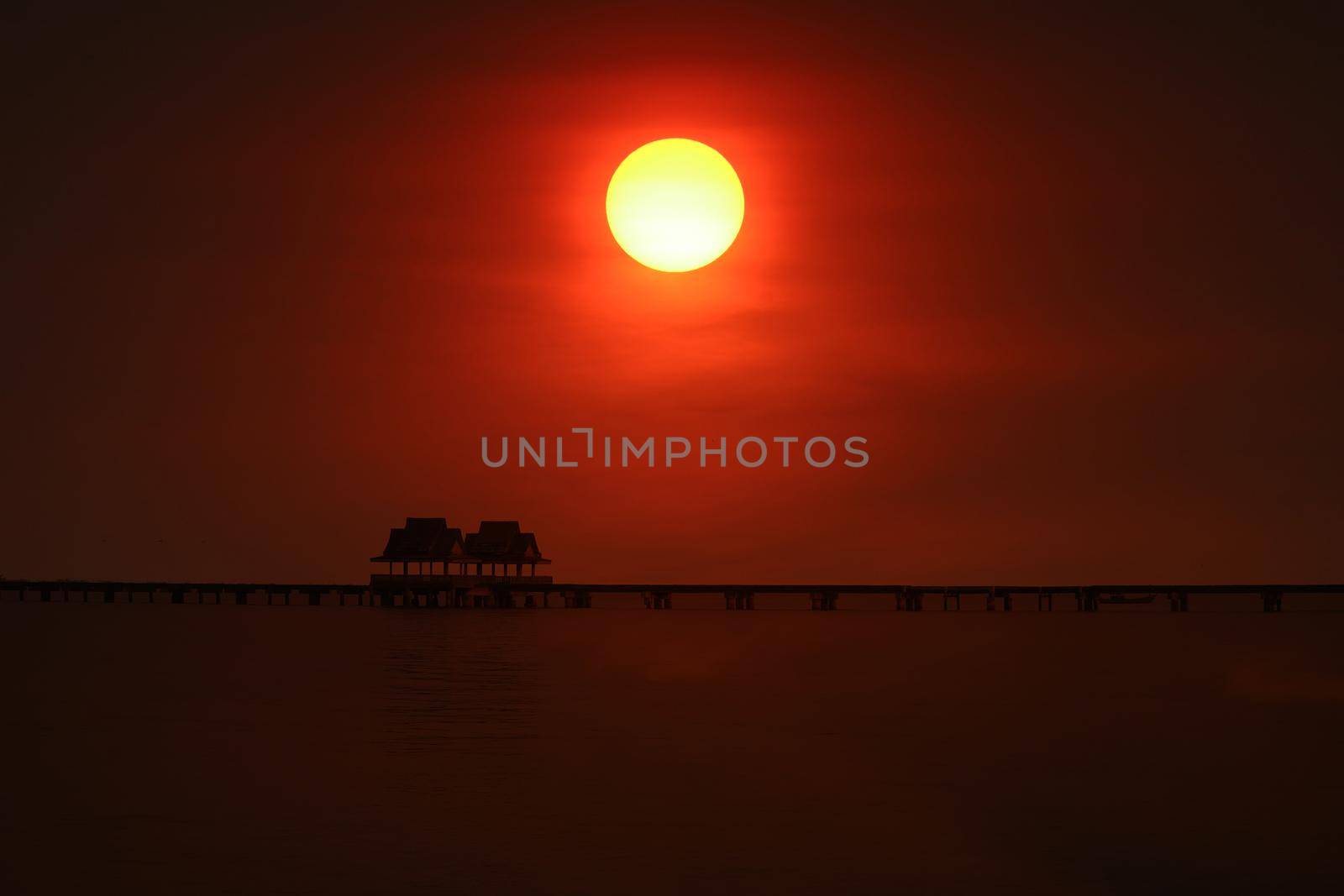 sunset back on silhouette bridge and abandon pavillion in sea by Darkfox