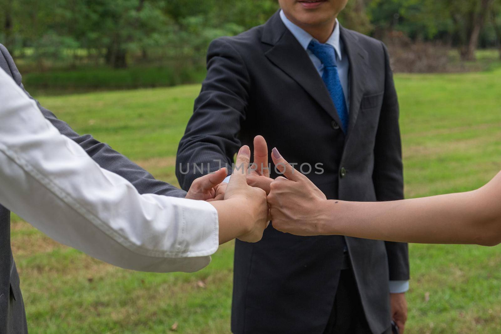 Business team showing hand of success symbol. by itchaznong