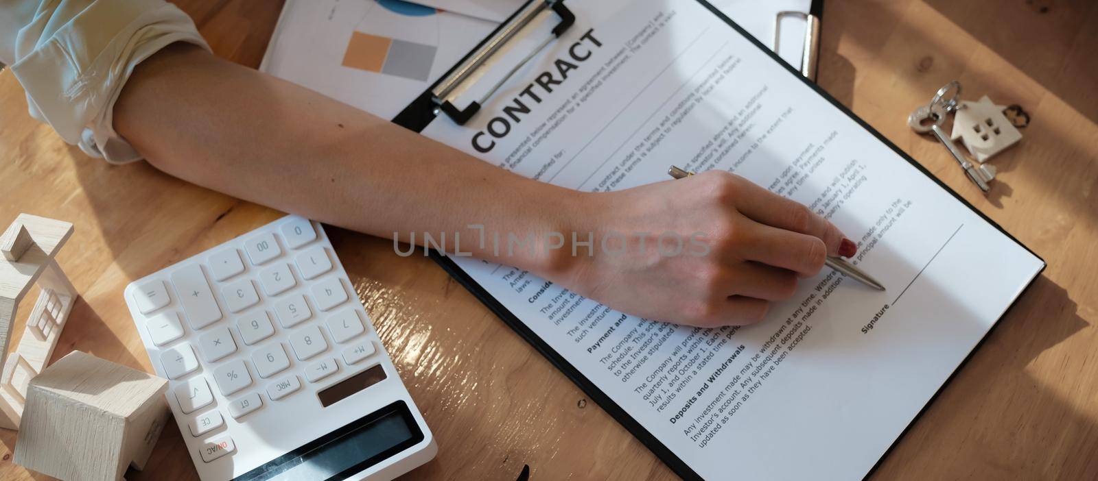 Businesswoman puts signature on contract at business meeting and sign in contract with business partners