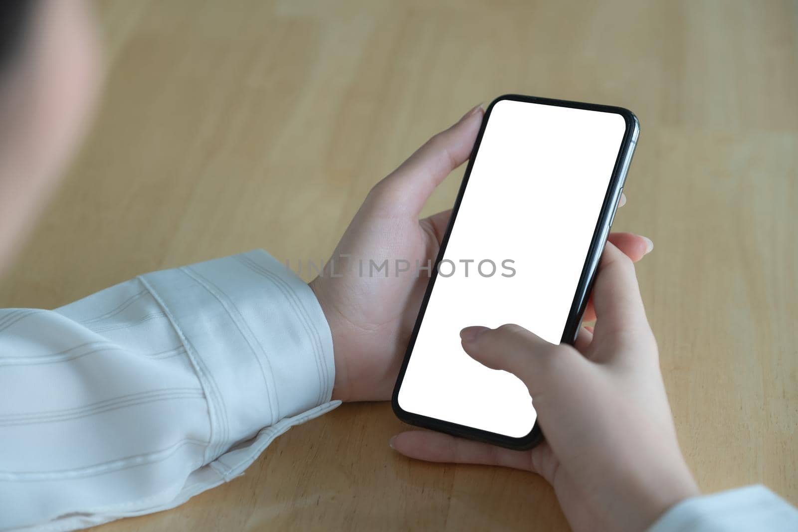 Asian woman holding smartphone with blank screen frameless modern design. Technology concept