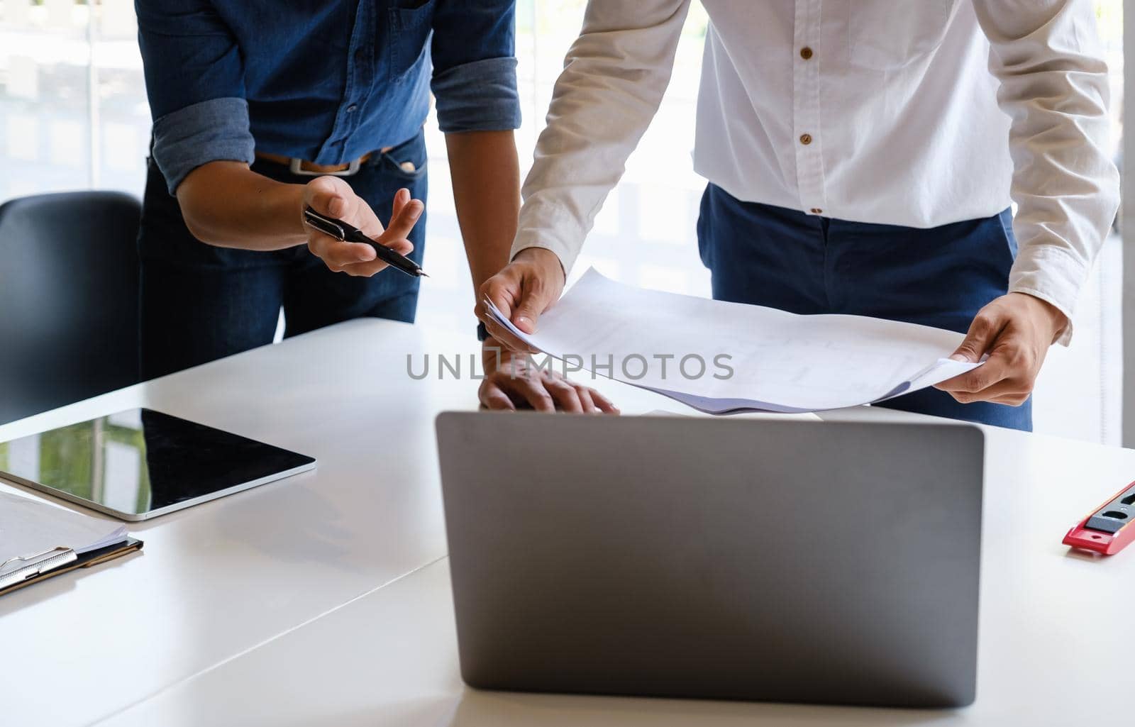 Two Architect man working with laptop and blueprints for architectural plan, engineer sketching a construction project concept