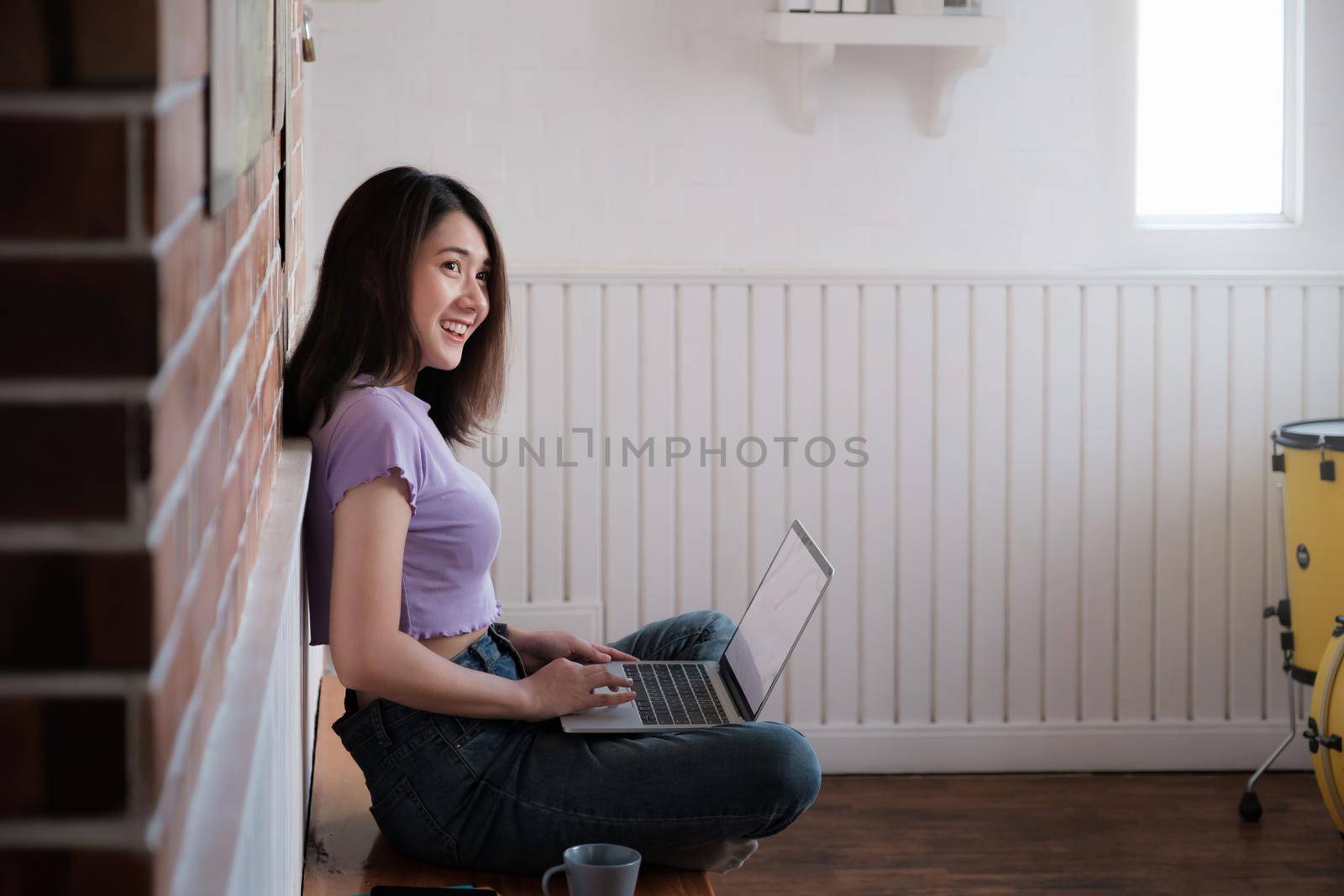 Portrait of beautiful woman and smiling using video call on laptop computer with her parents. Quarantine and work from home concept