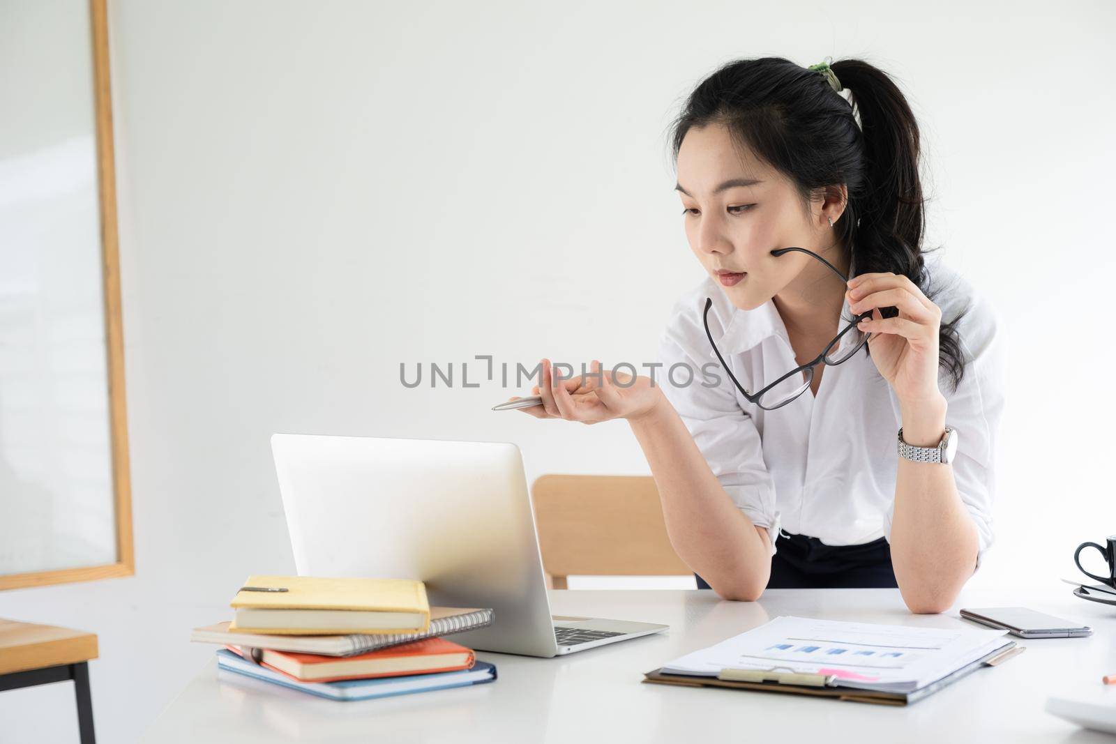 Portrait of Asian Business woman working from home. Accounting concept. by itchaznong