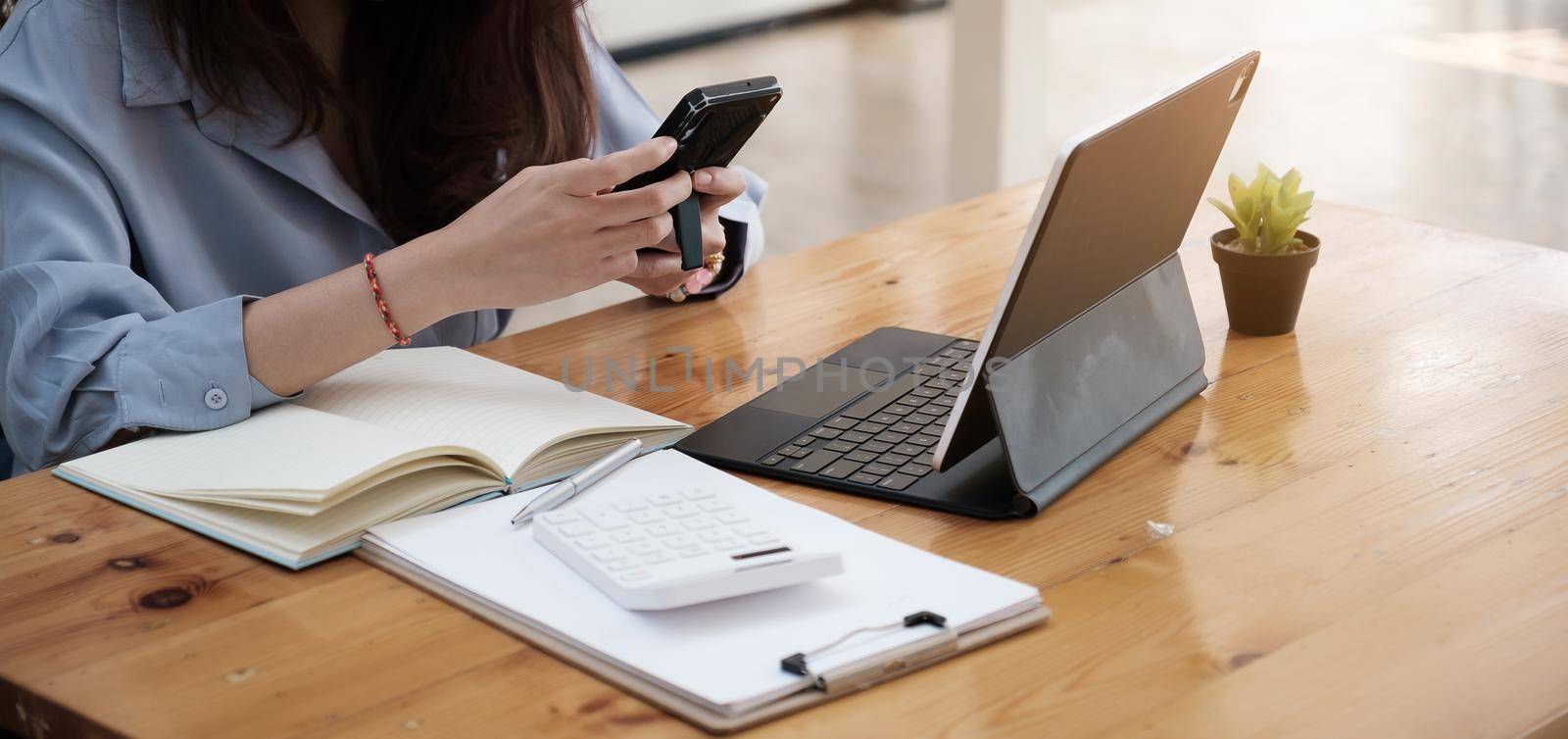 Closeup business woman using smartphone and checking meeting schedule ,Work From Home concept