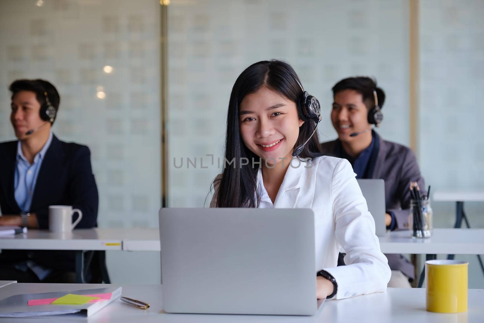 Female operator with her team before communicates with the client