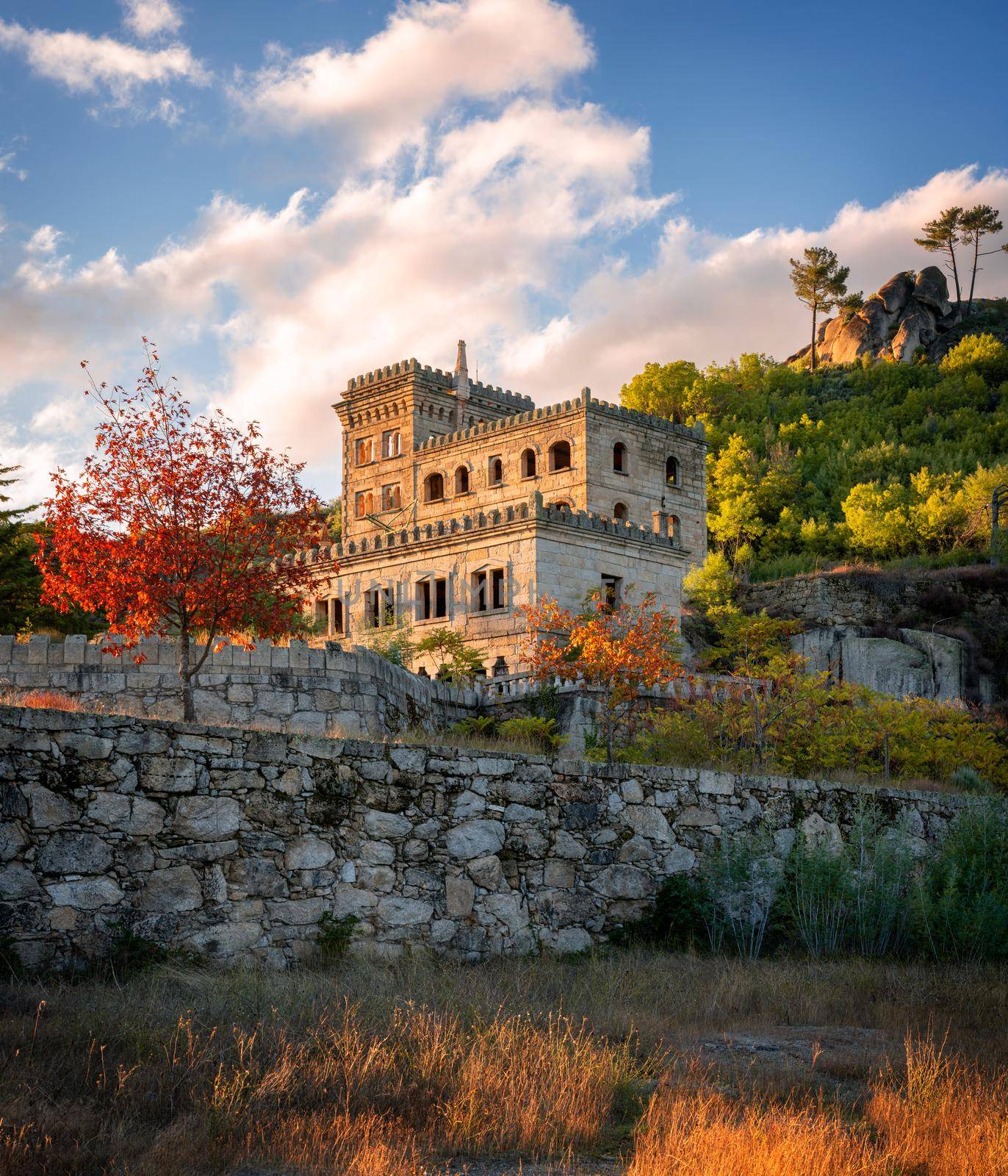 Abandoned ruin building of Termas Radium Hotel Serra da Pena in Sortelha with beautoful colorful trees at sunset, Portugal by Luispinaphotography