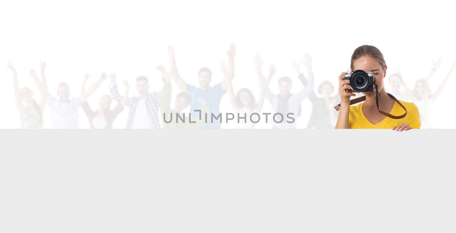 Young photographer girl with camera over many customers people isolated white background, blank banner with copy space for text