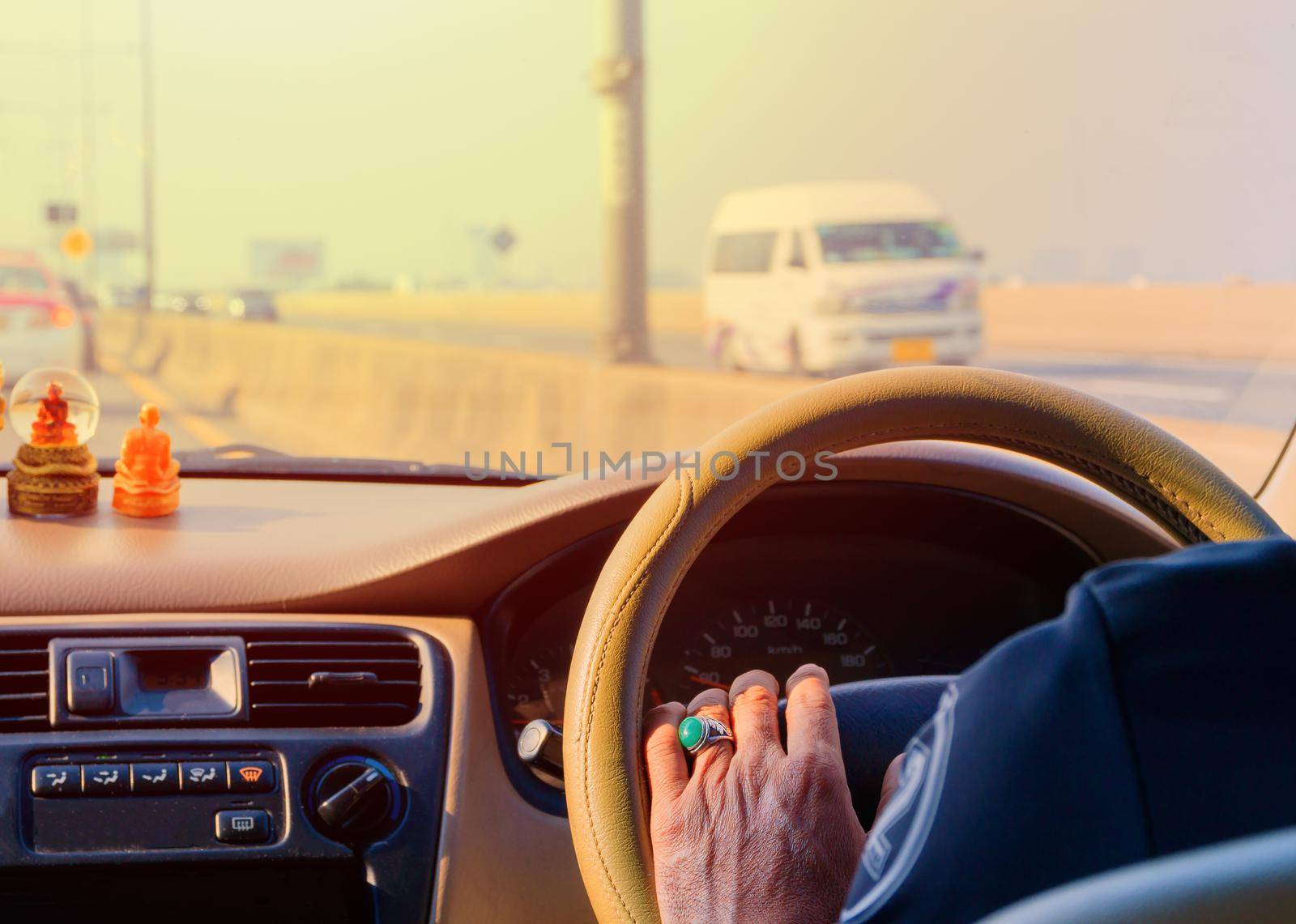 hand of man driving car travel on road Traffic jam and sunlight by pramot
