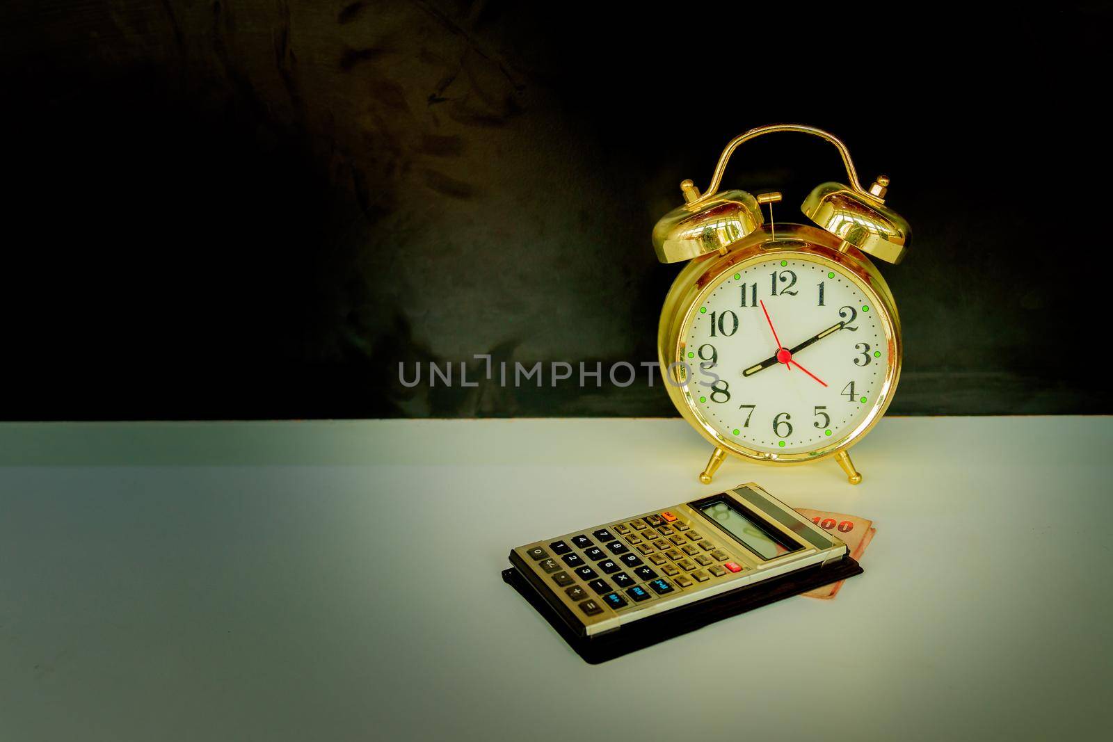 calculator and alarm clock old vintage gold over white and black background. with copy space add text retro style by pramot