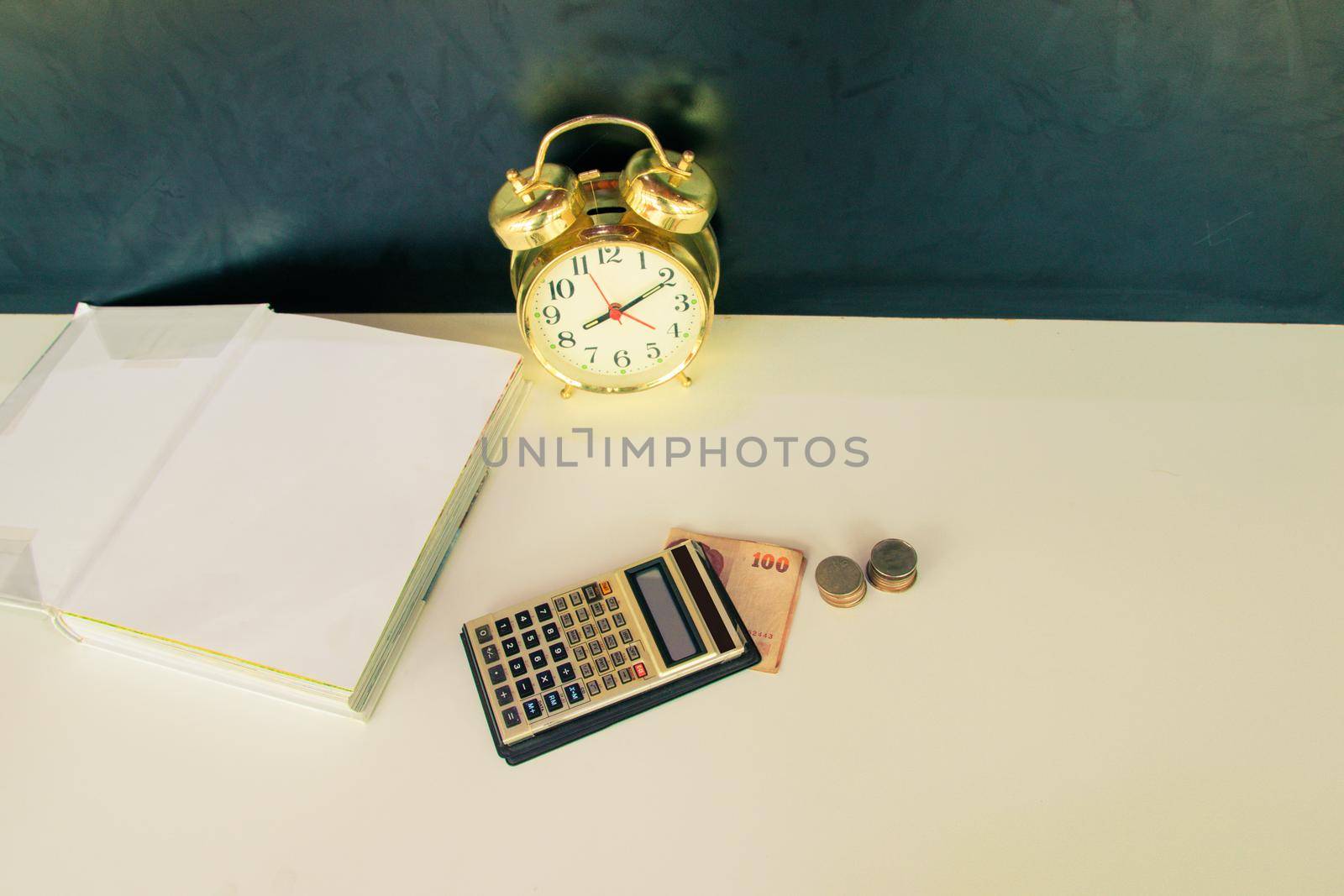 calculator old, money and alarm clock old vintage gold over white and black background. with copy space add text. color vintage style tone