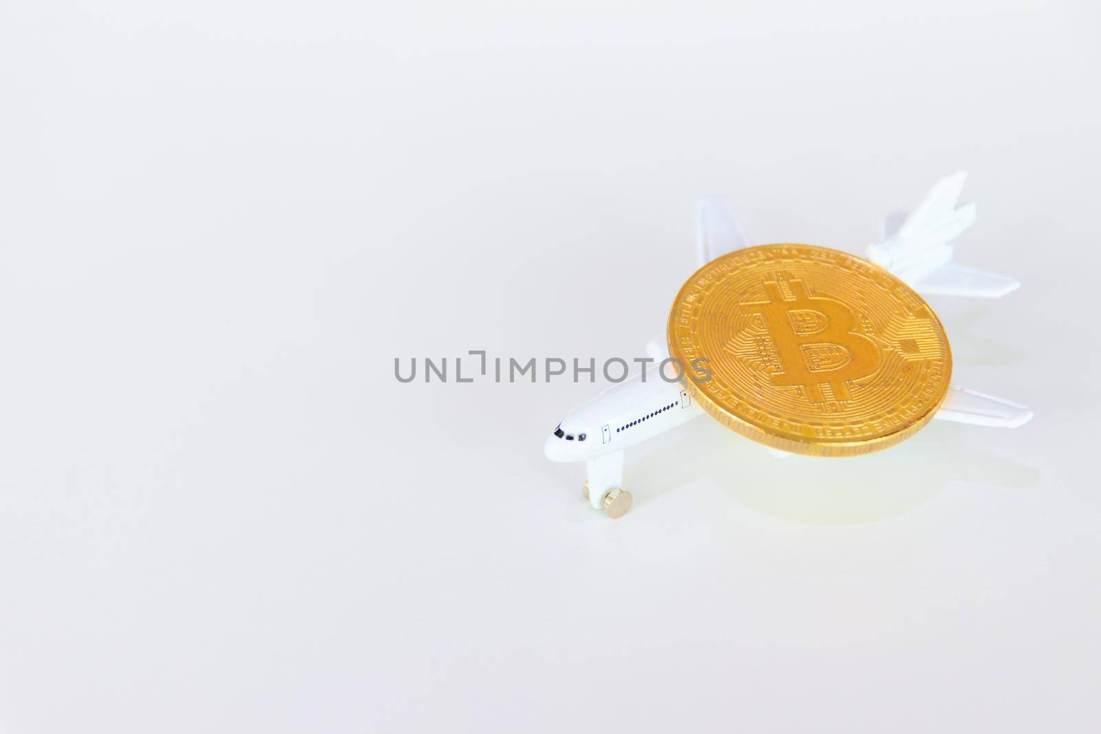 bitcoin coins above model of passenger plane  over white on black background. with copy space add text Top view by pramot