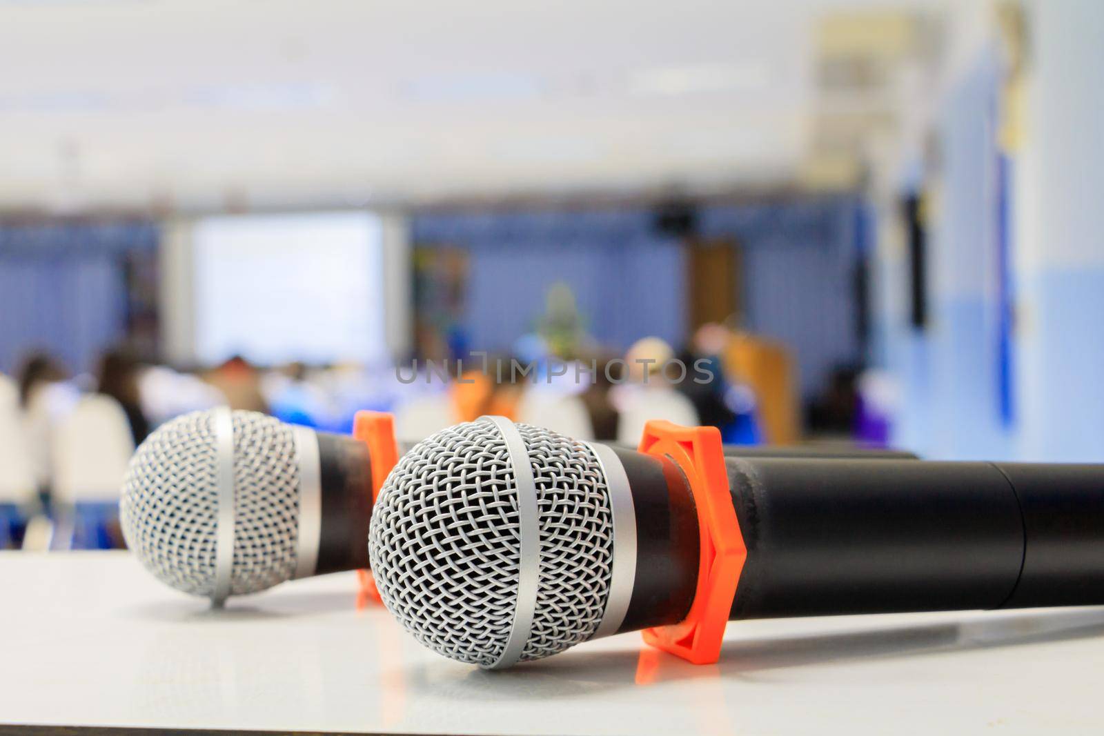Close up microphone wireless old on the table in the conference and Background blur interior seminar meeting room