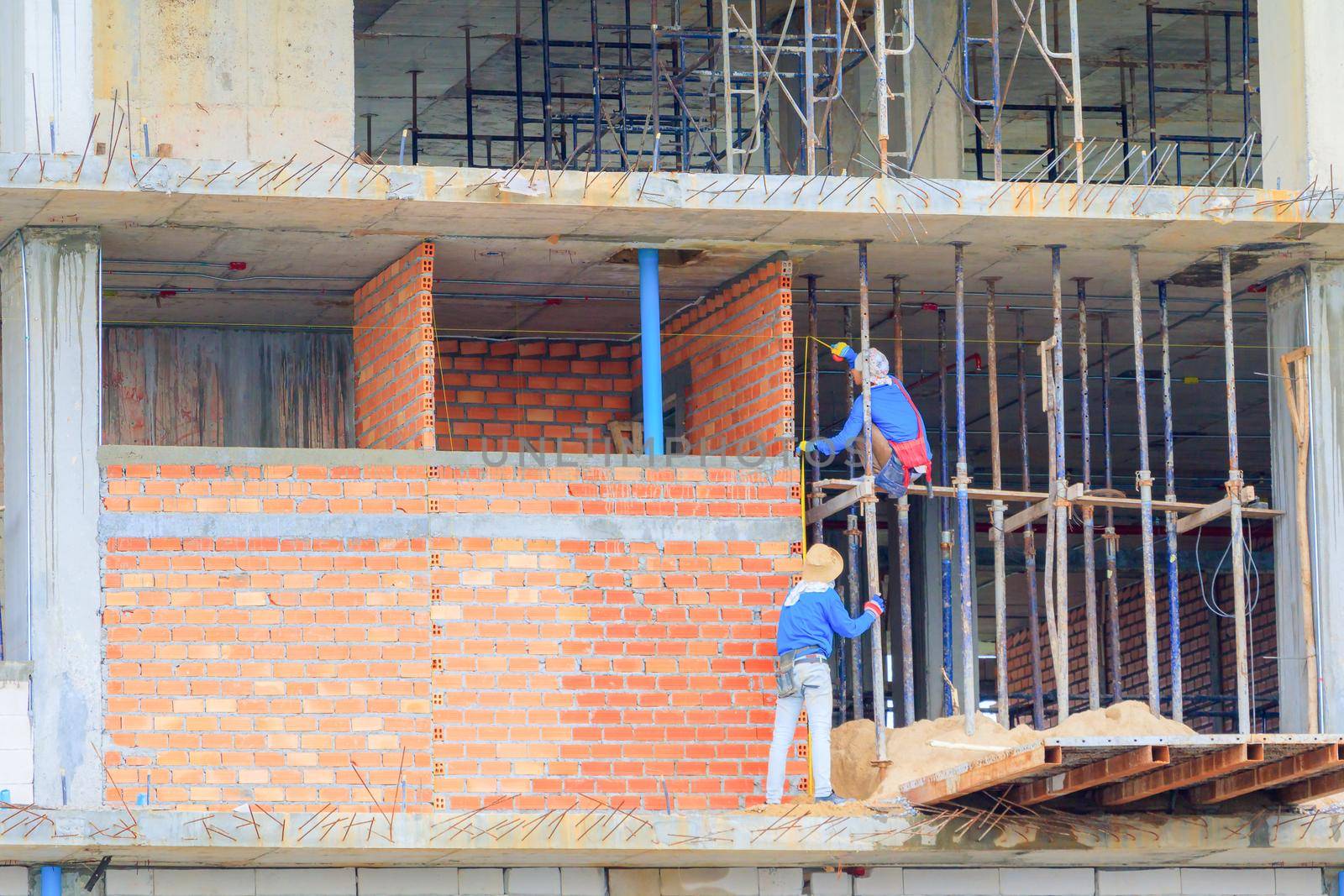 construction workers building develop of housing at laborer work outdoor. by pramot